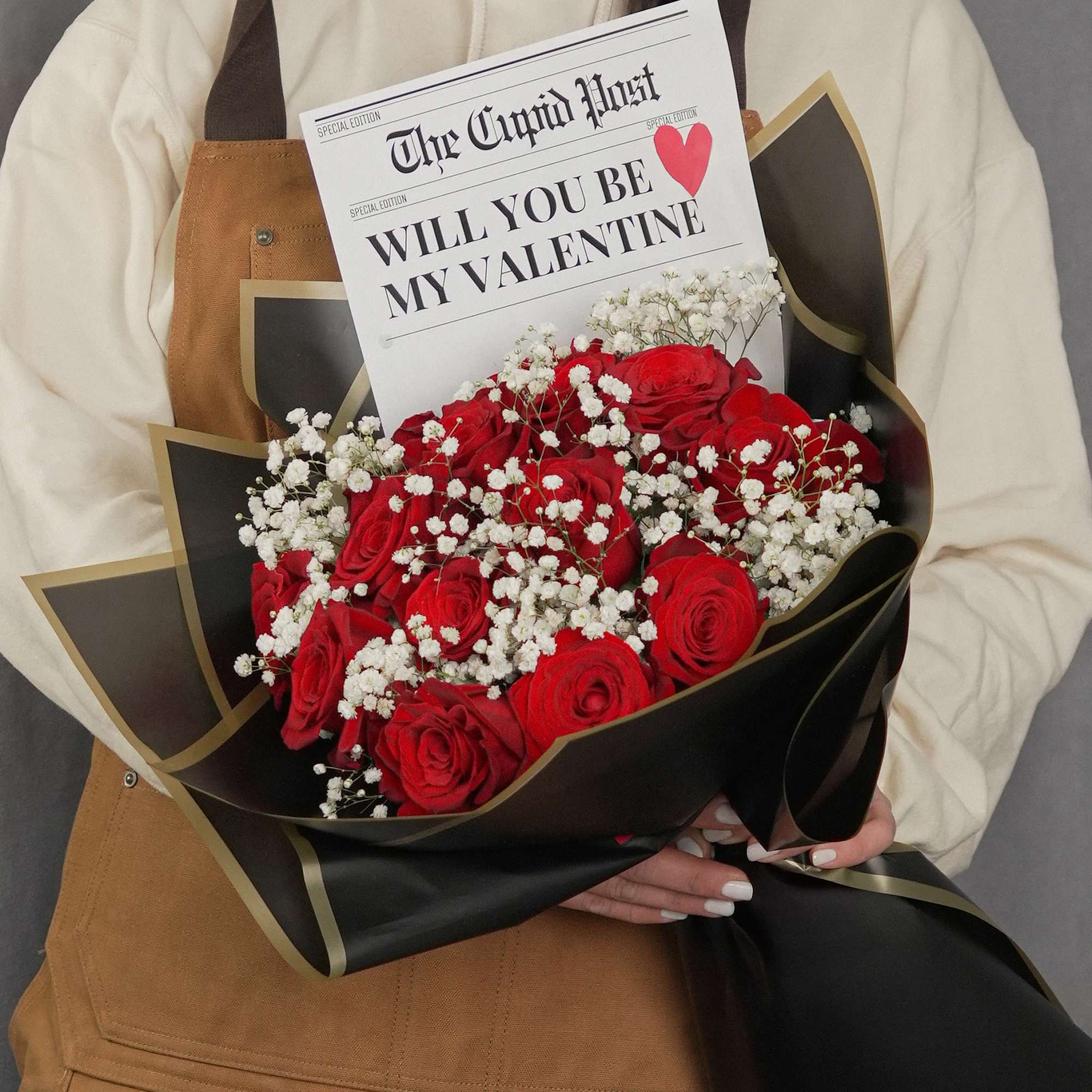 Striking bouquet featuring 12 premium red roses, imported from Ecuador, wrapped in