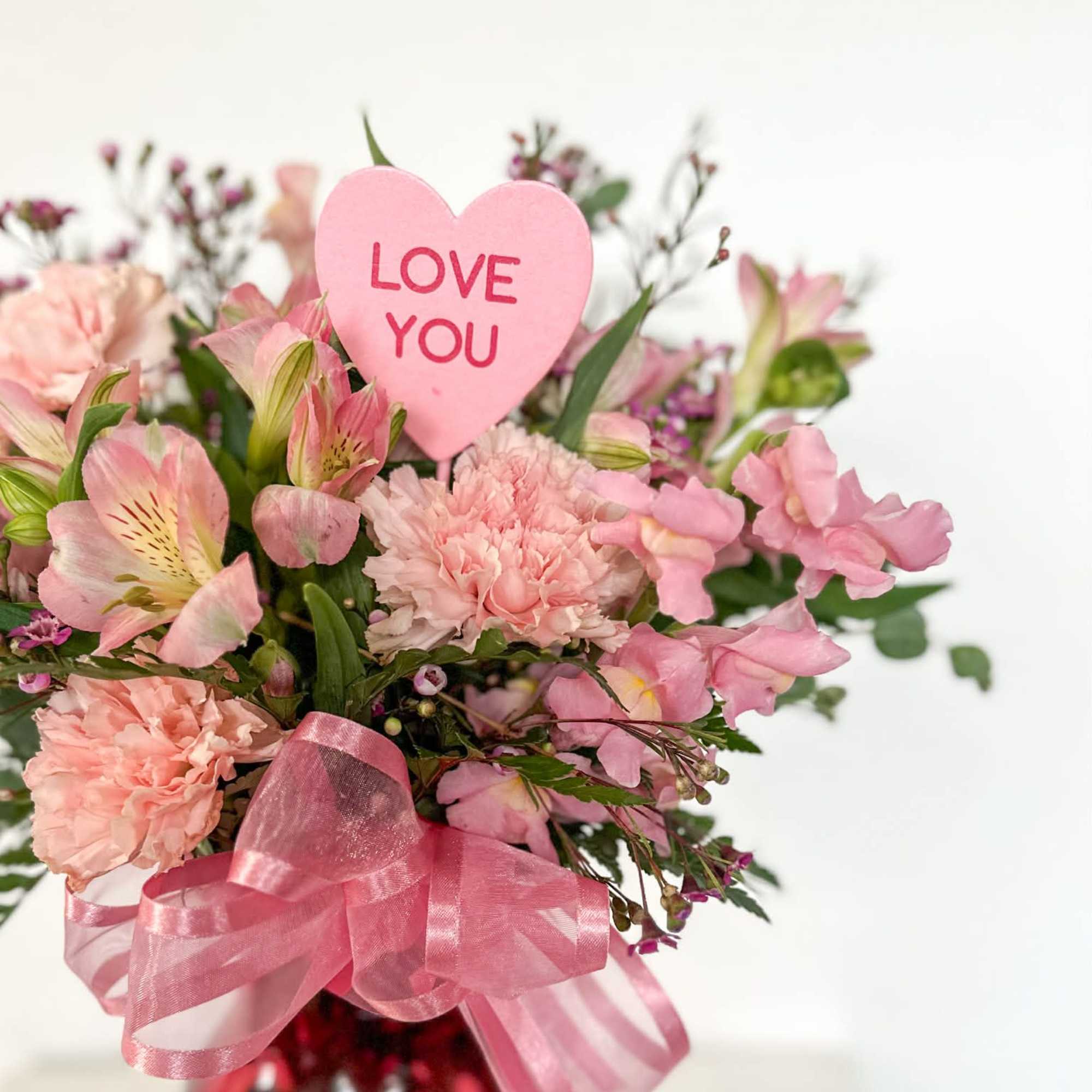PINK is a soft and romantic arrangement featuring blush pink carnations, delicate