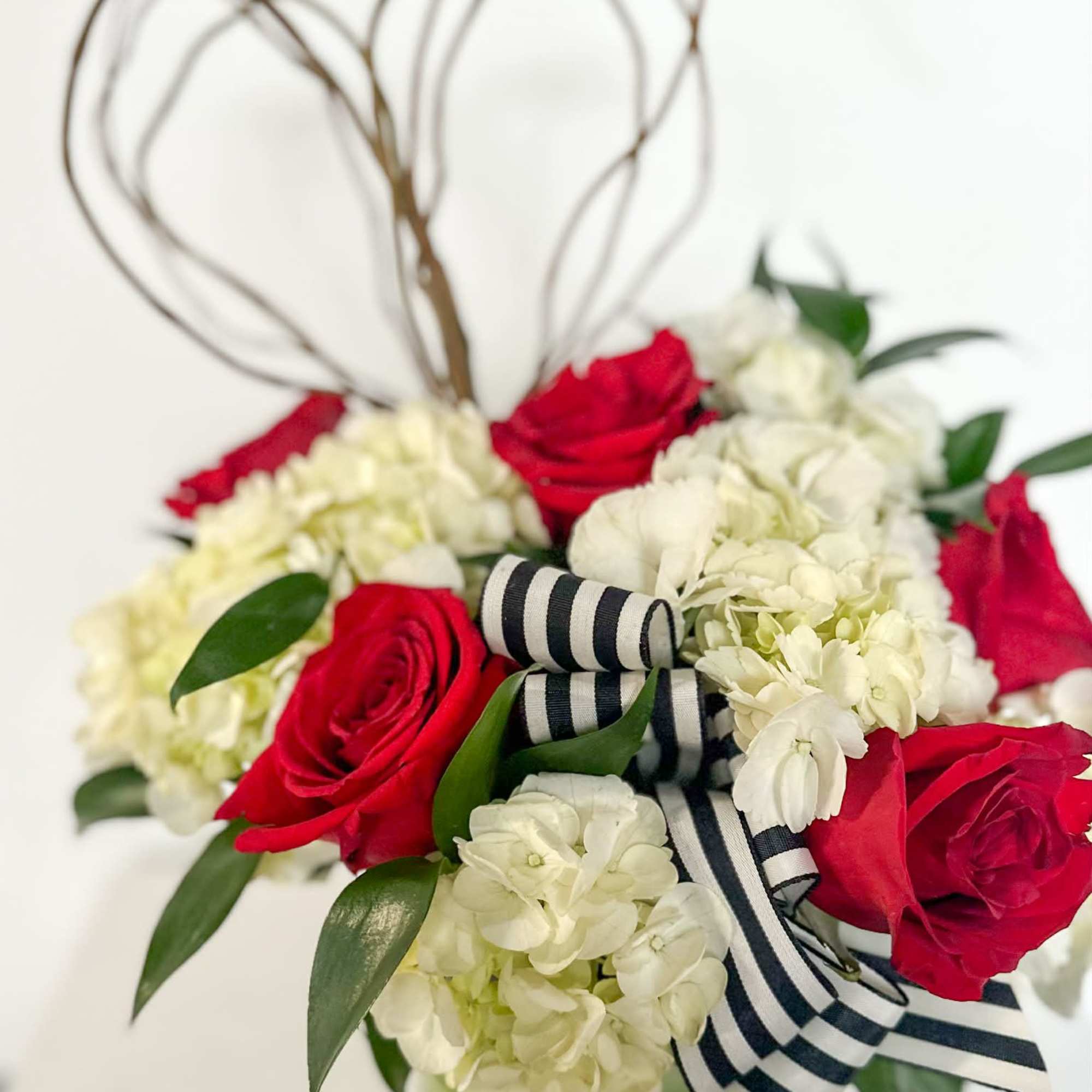 Modern Love is a striking and contemporary arrangement featuring classic red roses