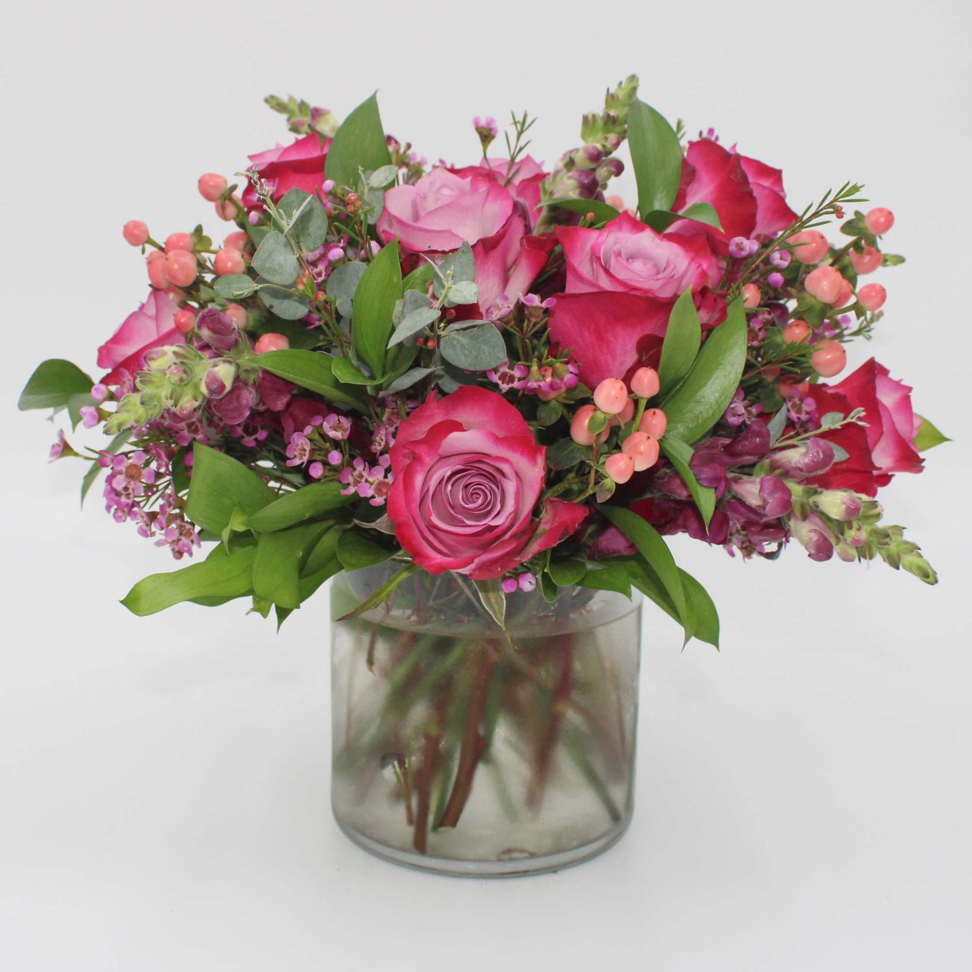 Plume features Purple Roses, Pink Hypericum Berries, Purple Waxflower, Purple Snapdragon, Italian