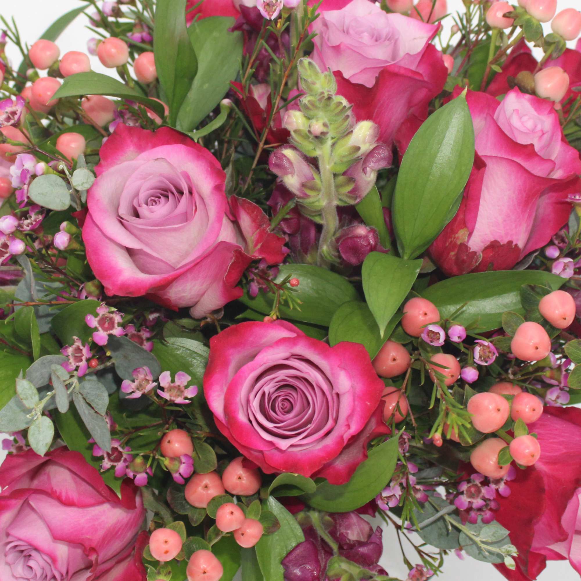 Plume features Purple Roses, Pink Hypericum Berries, Purple Waxflower, Purple Snapdragon, Italian
