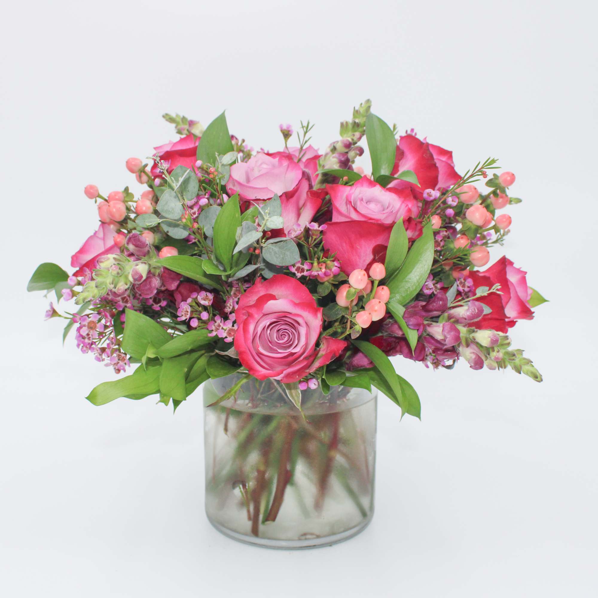 Plume features Purple Roses, Pink Hypericum Berries, Purple Waxflower, Purple Snapdragon, Italian