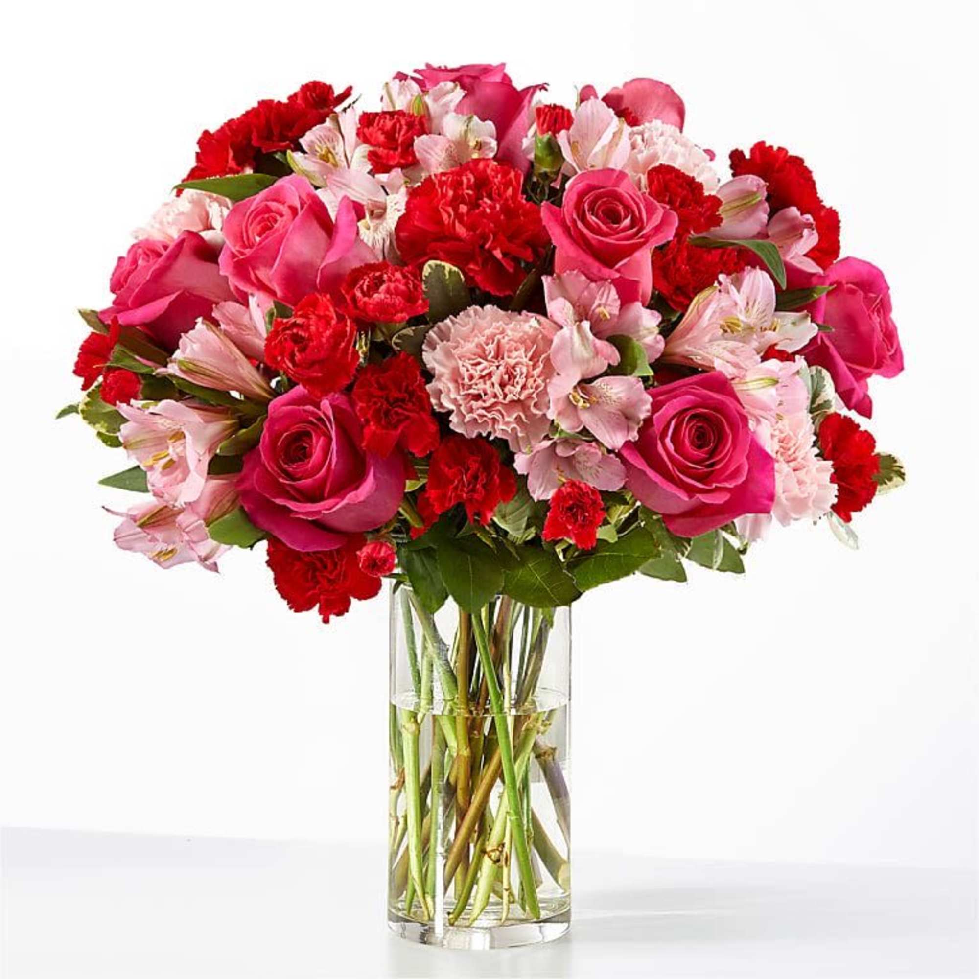 A vibrant blend of hot pink roses, red accents, and soft pink