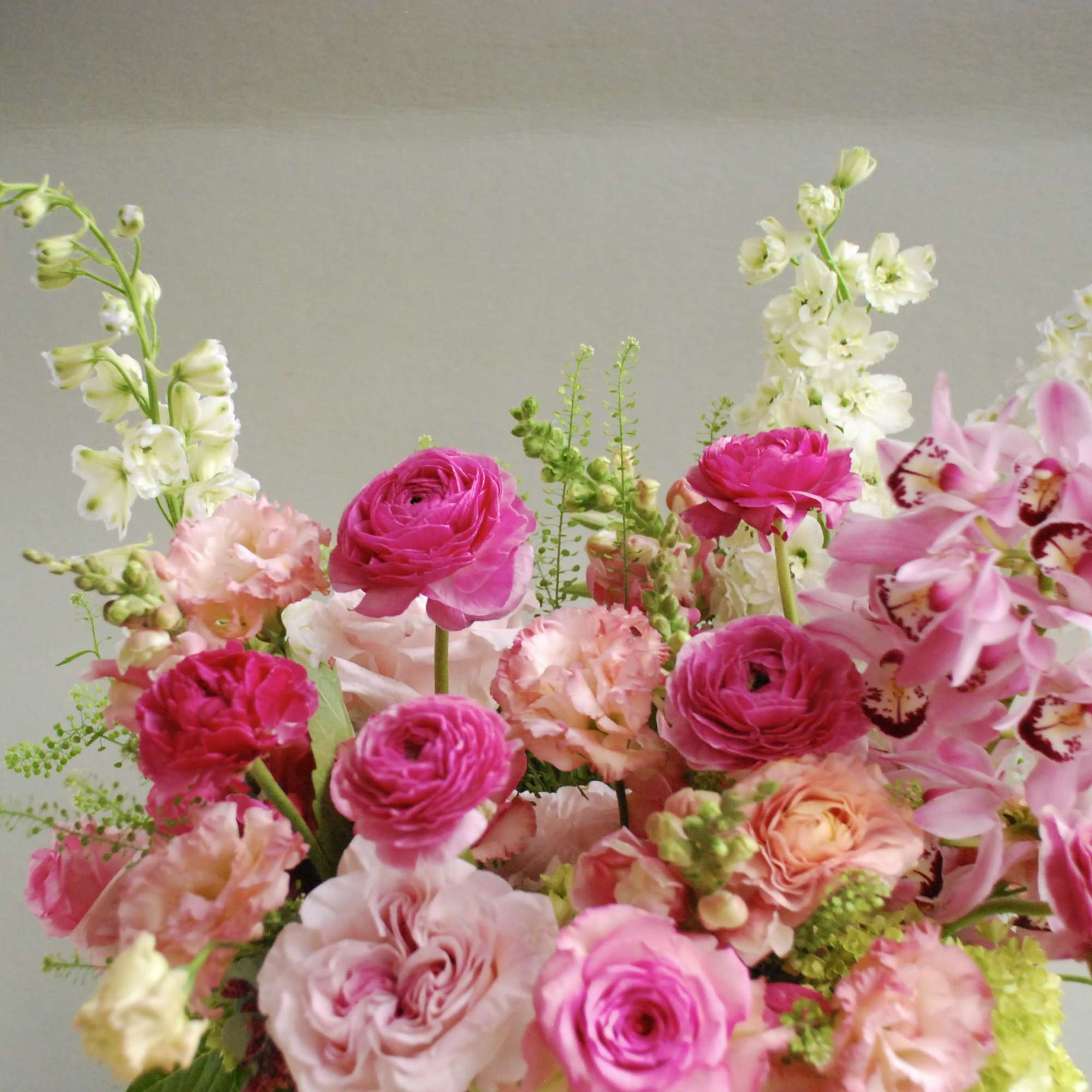 Lush and joyful, this arrangement celebrates shades of pink in a full