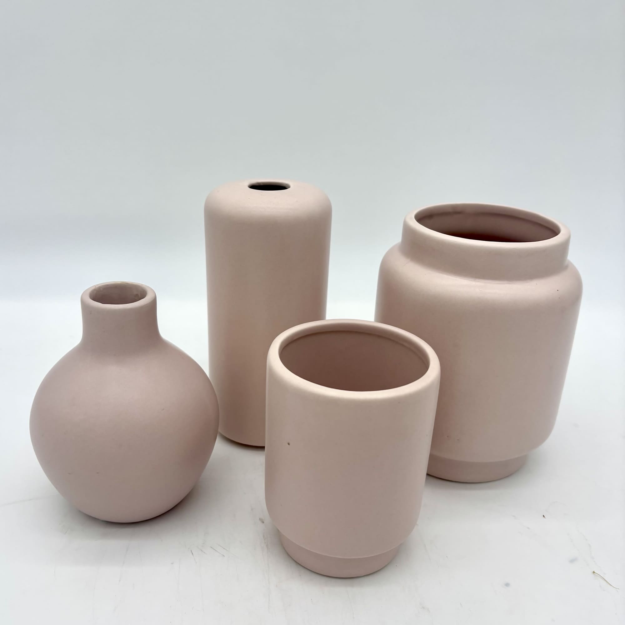 Our designers will create a charming collection of three pale pink ceramic