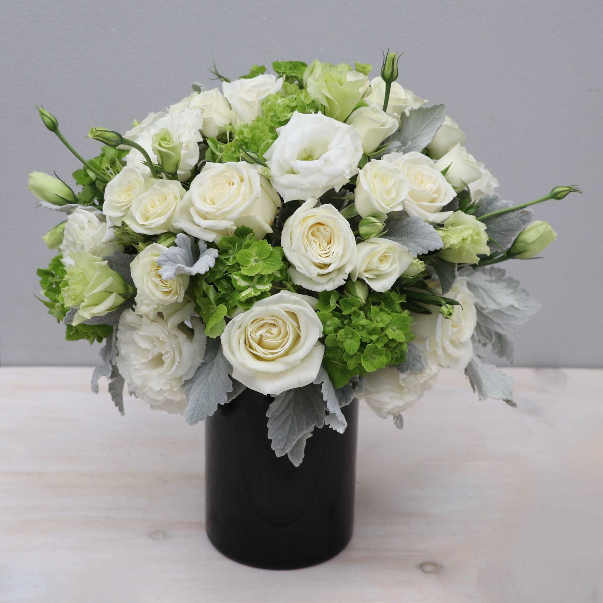 This Gatsby inspired arrangement is overflowing with lush hydrangeas, lisianthus, and seasonal
