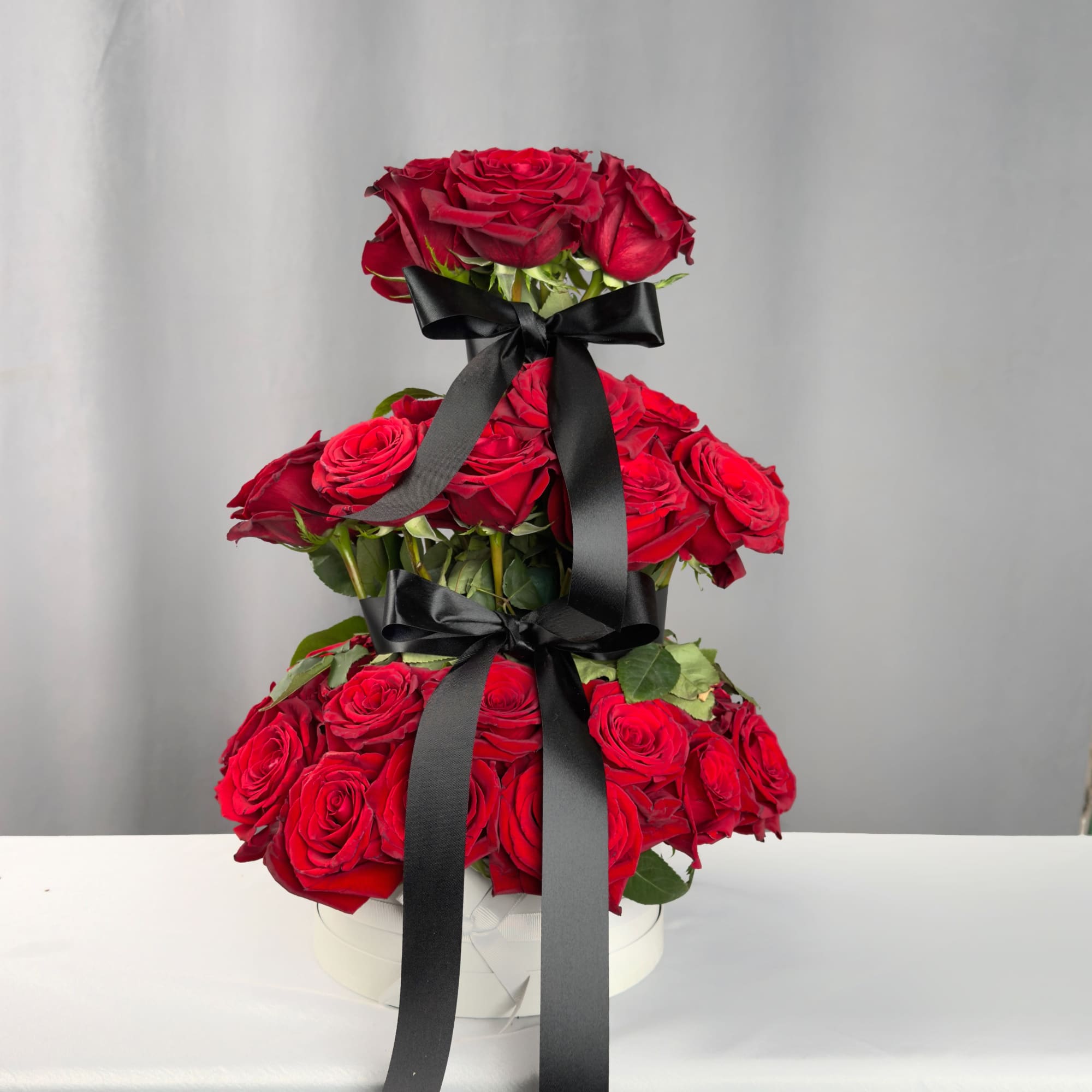 This stunning tower arrangement features 48 premium 50 cm roses, imported directly