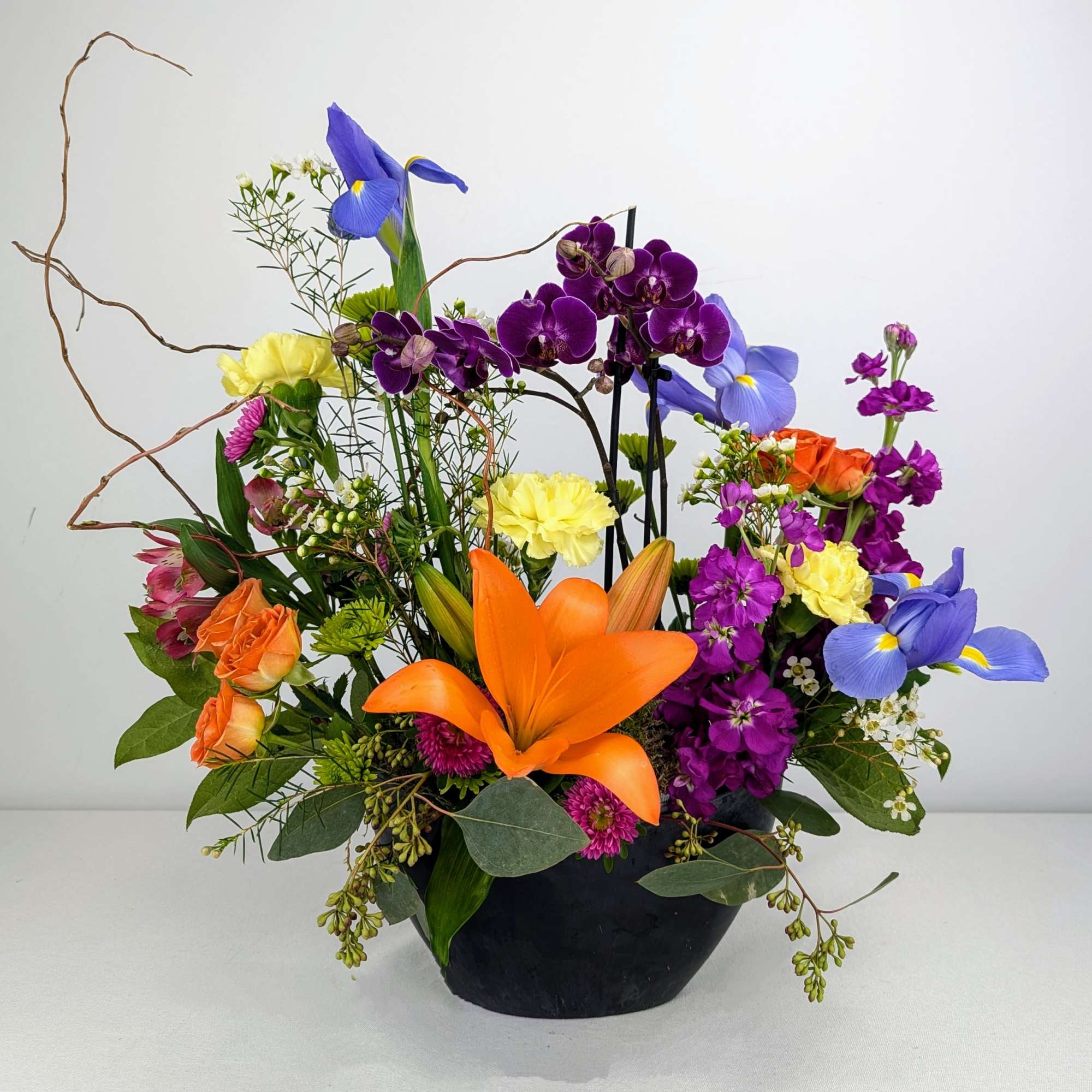 A bright and bold display of beautiful seasonal blooms that includes a