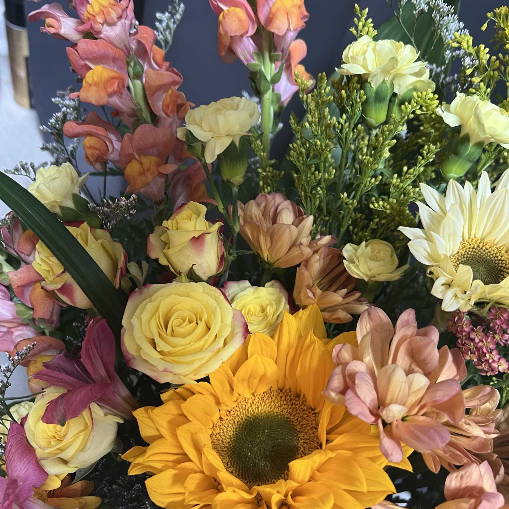 Bring joy to any celebration with this vibrant flower arrangement featuring a