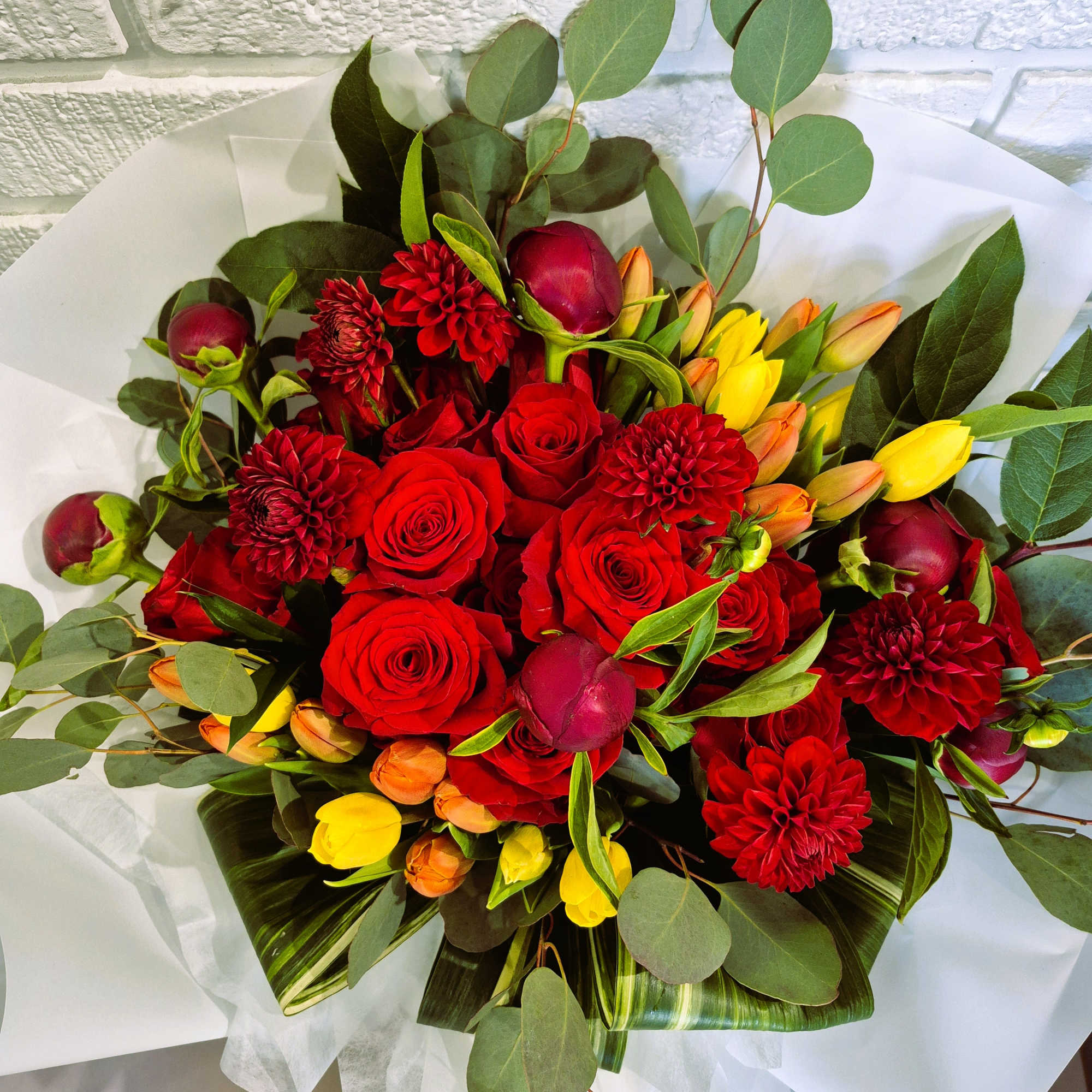 Burgundy Peonies, 2 dozon Red Roses with tulips and greenery hand bouquet.

If