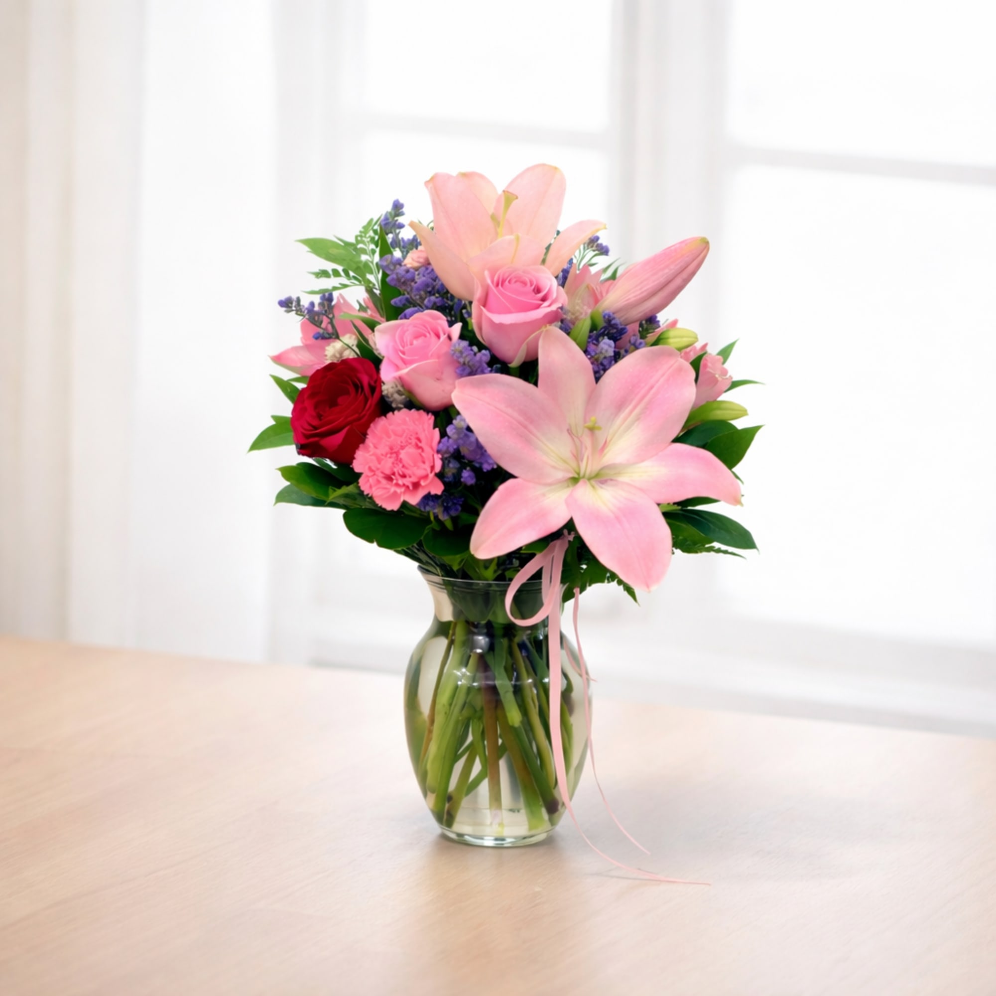 Soft Hues is a refined floral arrangement featuring layered pink tones and