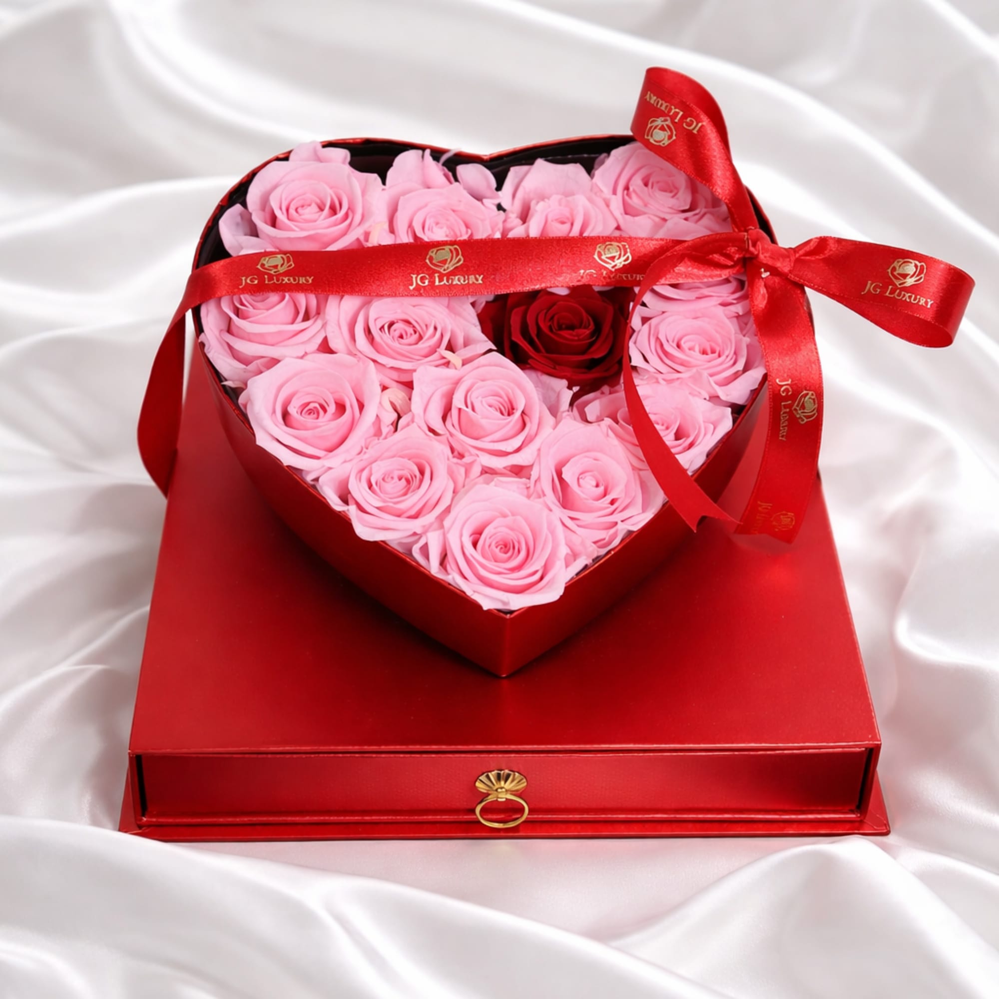 Red heart shaped box filled with soft pink natural roses and a