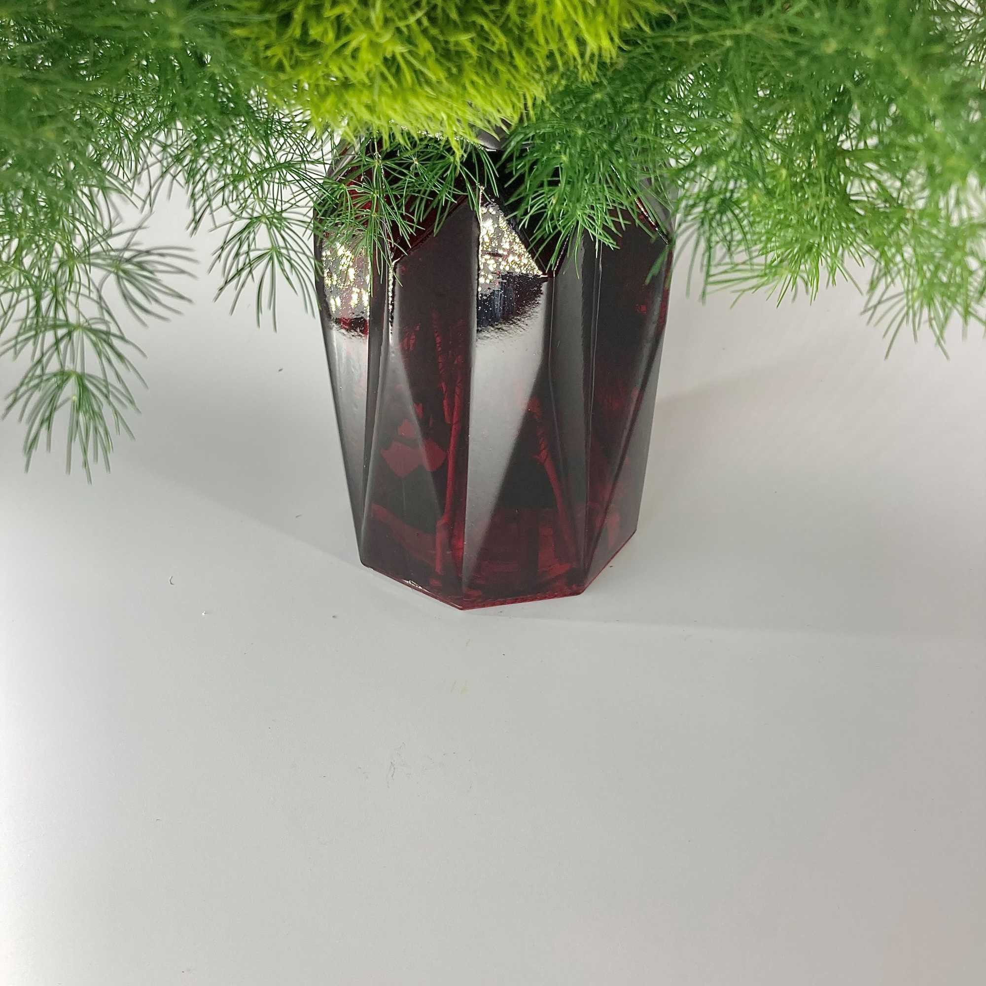 A beautifully designed white cut glass vase filled with a mixture of