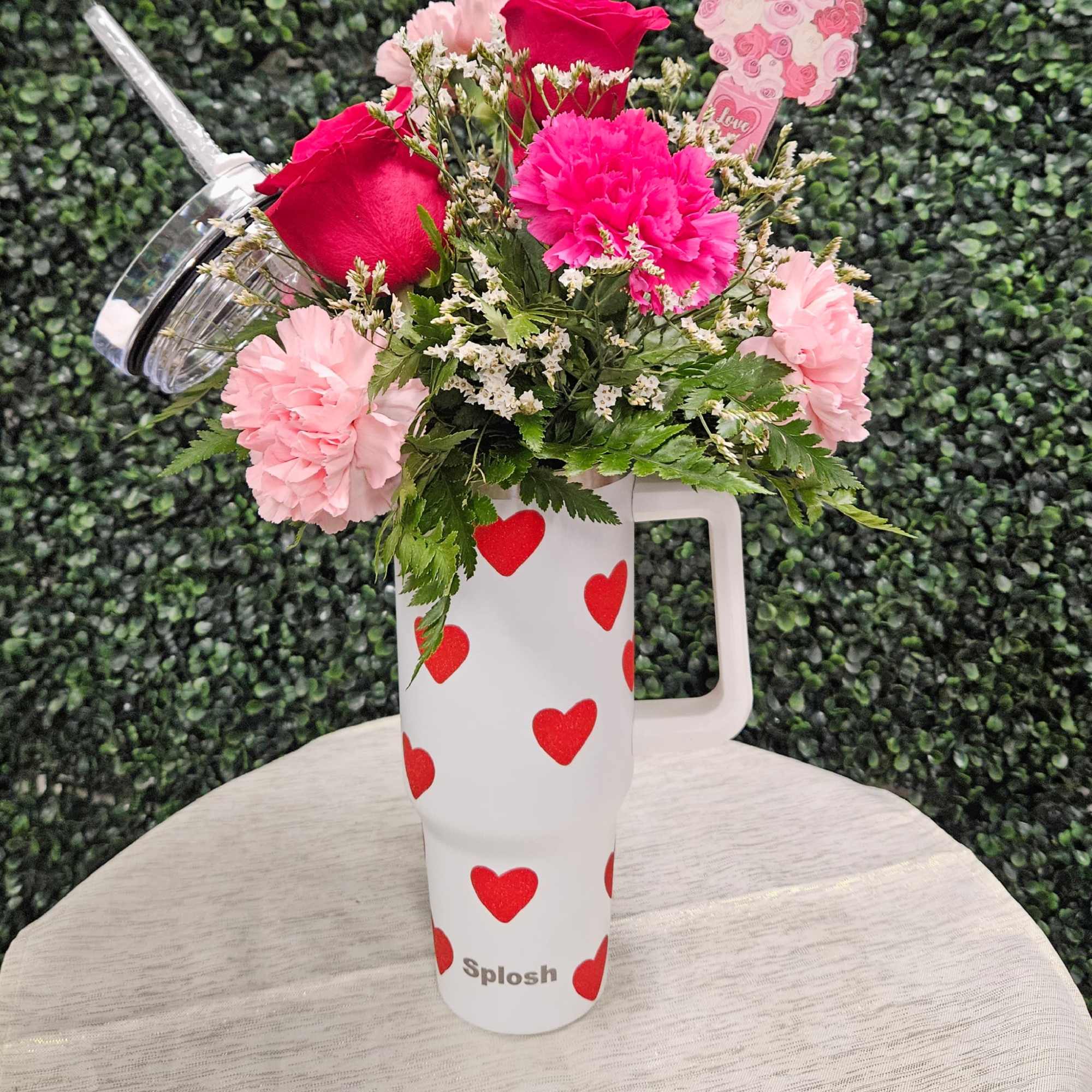 This arrangement of Roses and Carnations in an adorable 40 oz travel