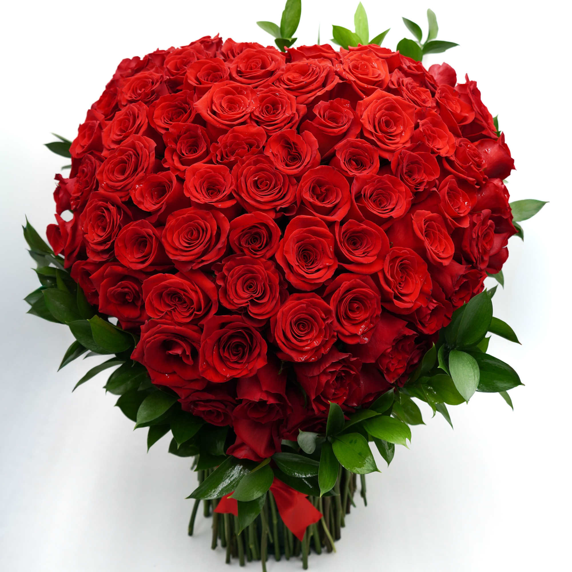 A breathtaking display of luxurious red roses arranged in a full, heart-shaped