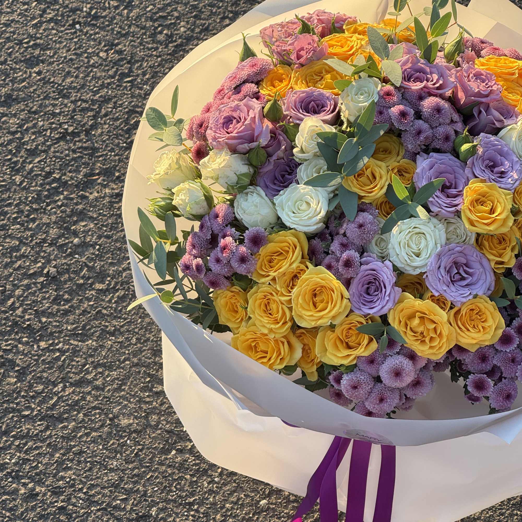 Bouquet with purple and yellow bush roses 