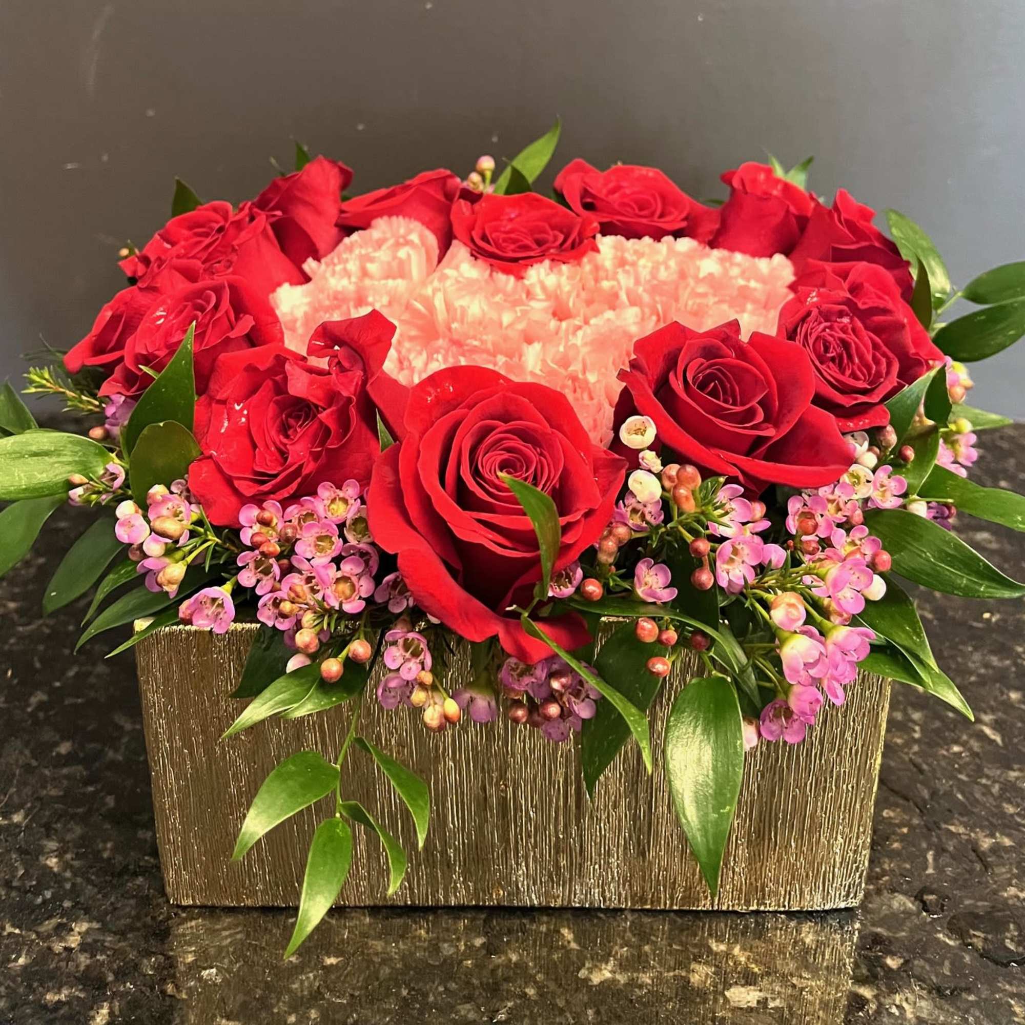This arrangement is short, fun and festive! It features 15 red roses
