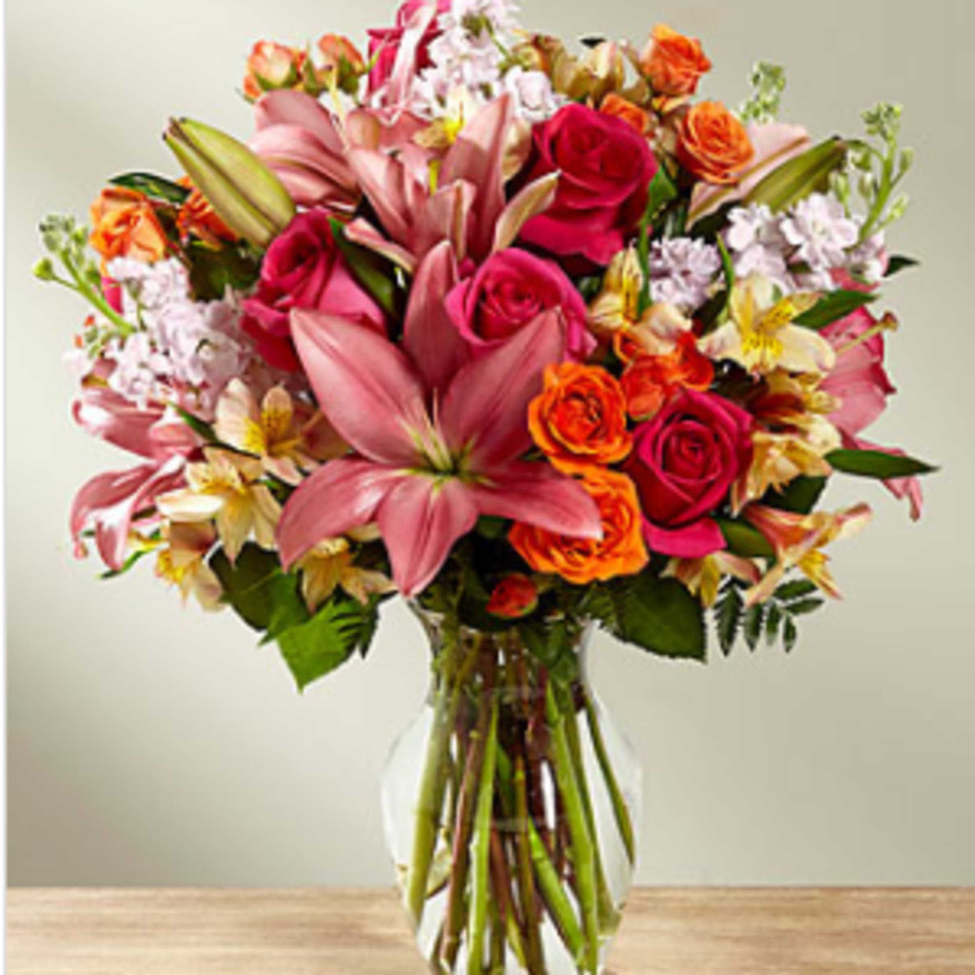Hot pink roses, orange spray roses, pink gilly flower, and pink Asiatic