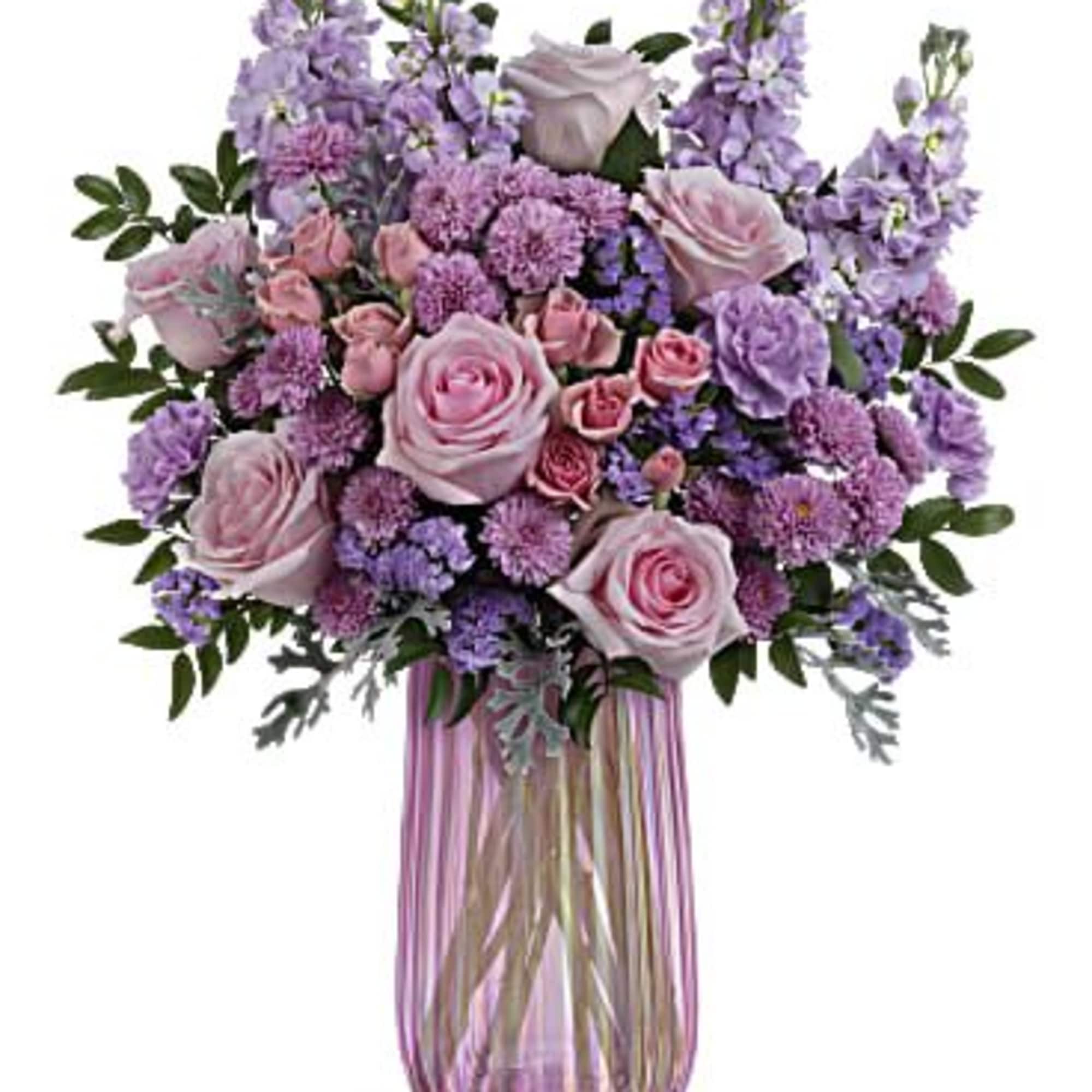 What a delight! Overflowing with pink roses and lavender blooms, this decadent