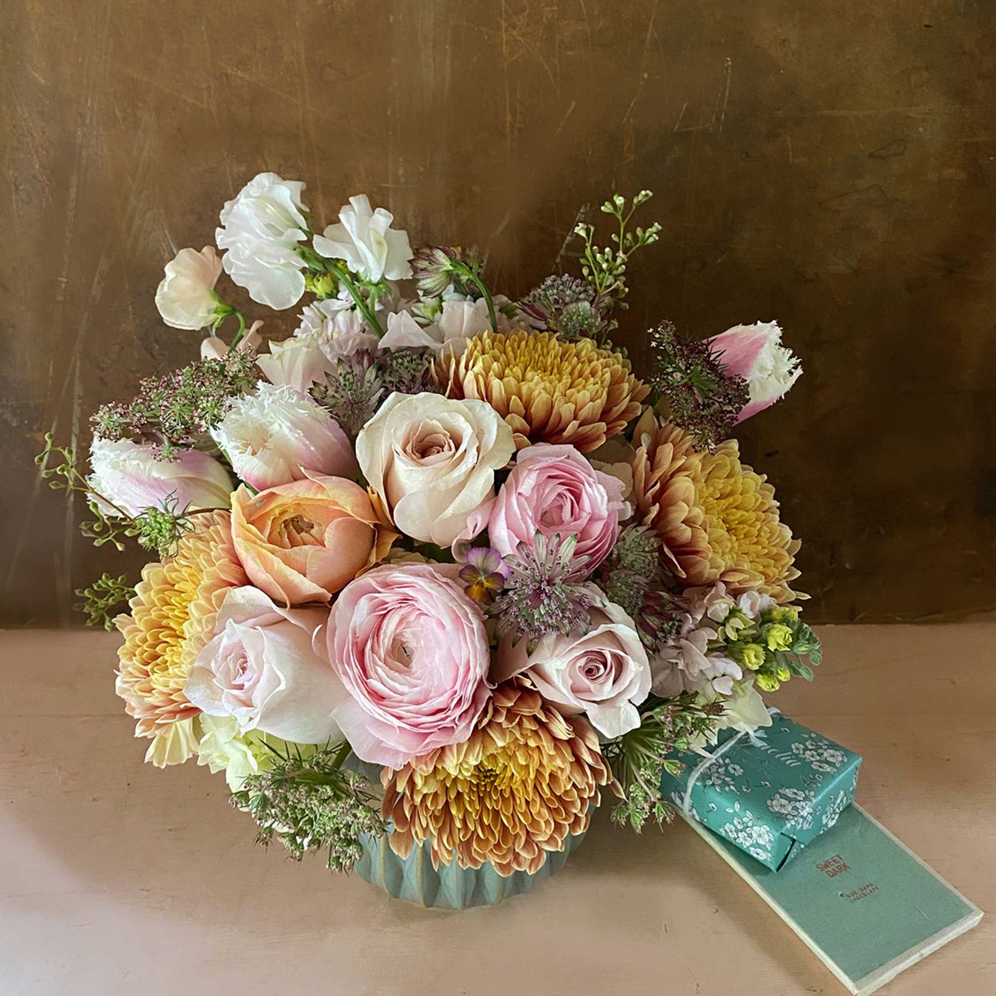 Make someone happy with the stylish arrangement of golden, dusty, blush colors