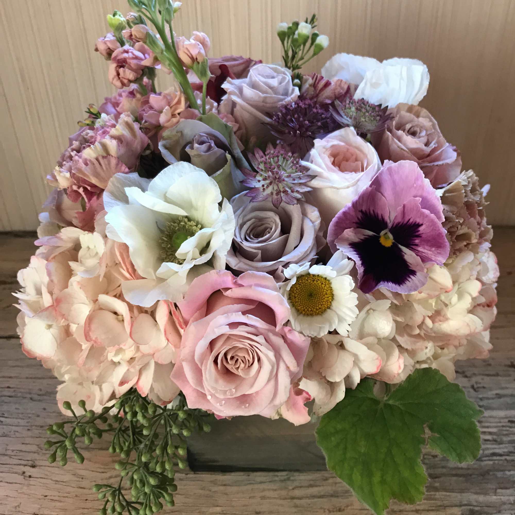 Gorgeous wooden box packed with pastel colored flowers. For the hippie, the