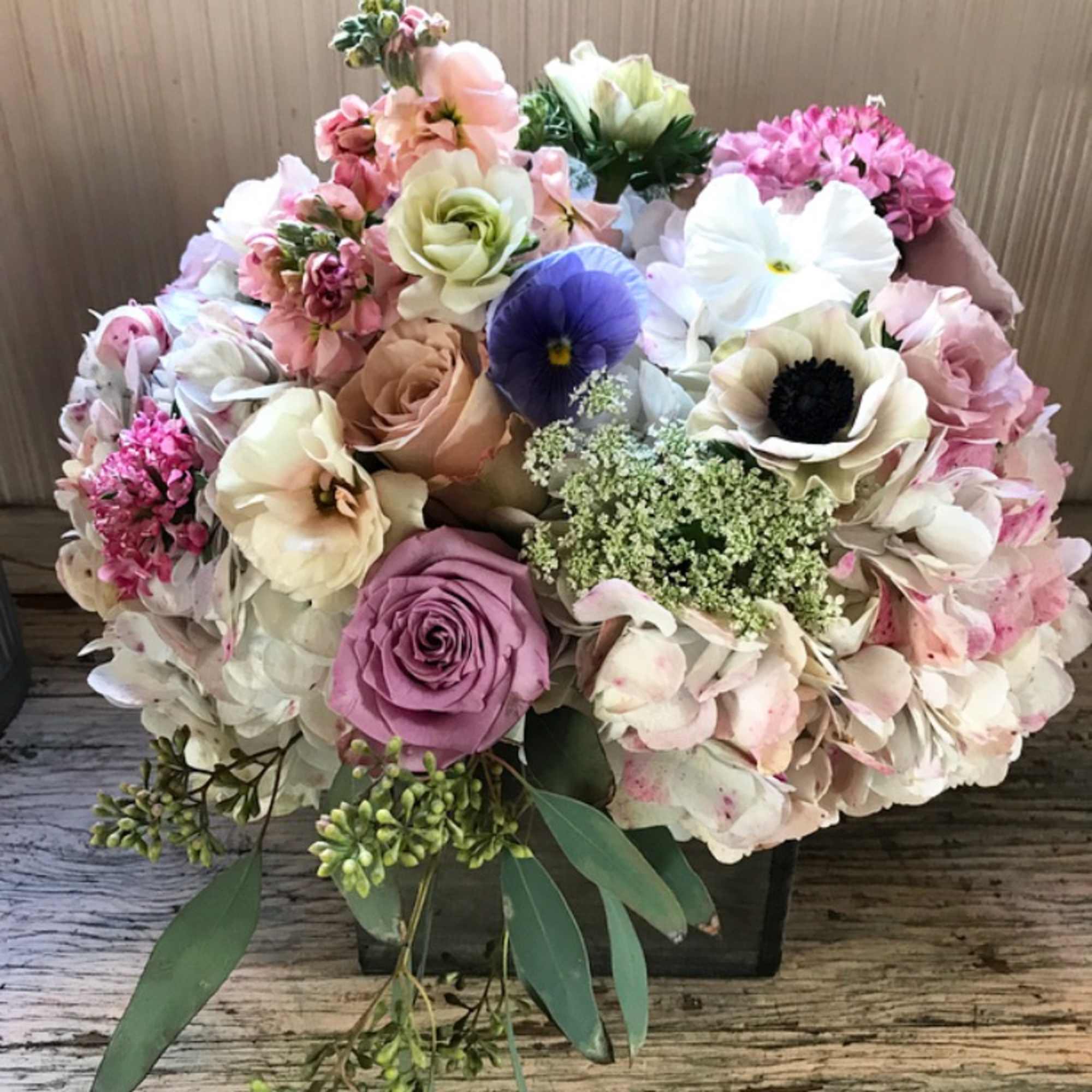 Gorgeous wooden box packed with pastel colored flowers. For the hippie, the