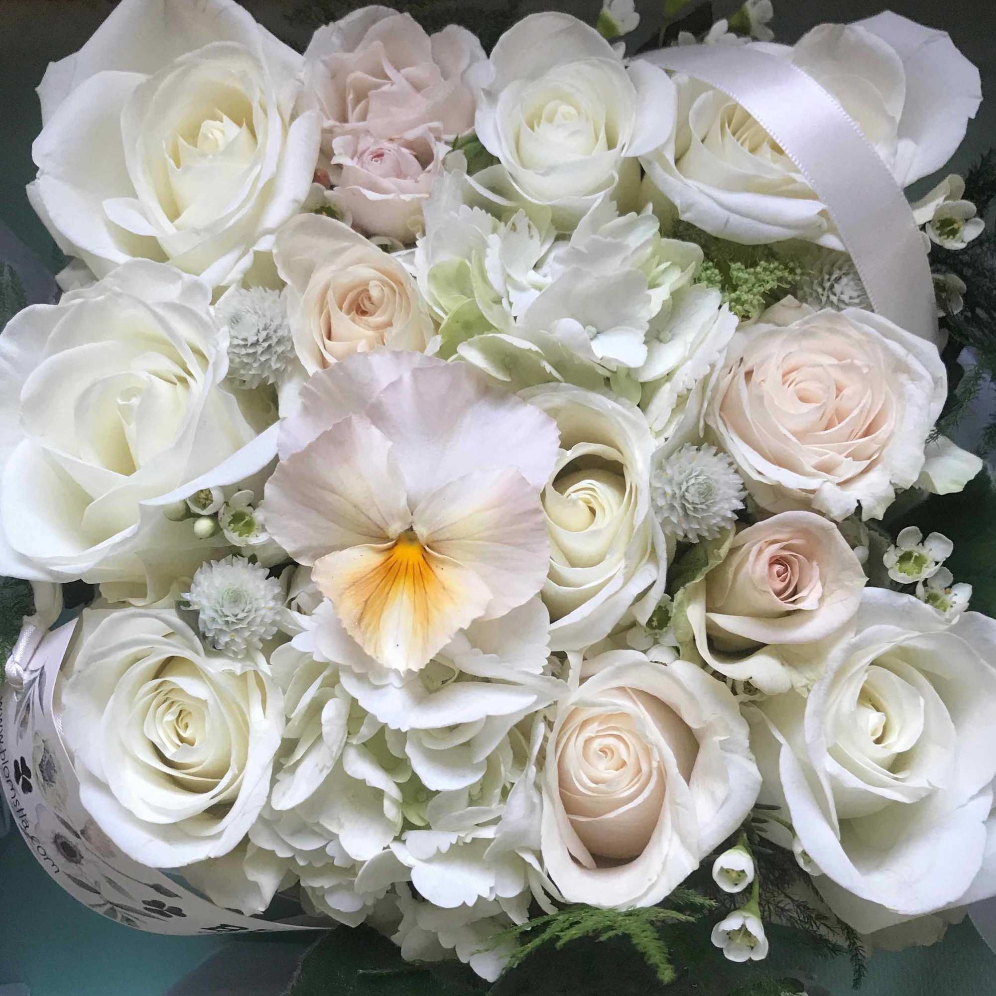 Beautiful blooming flower box full of fresh flowers in a white and