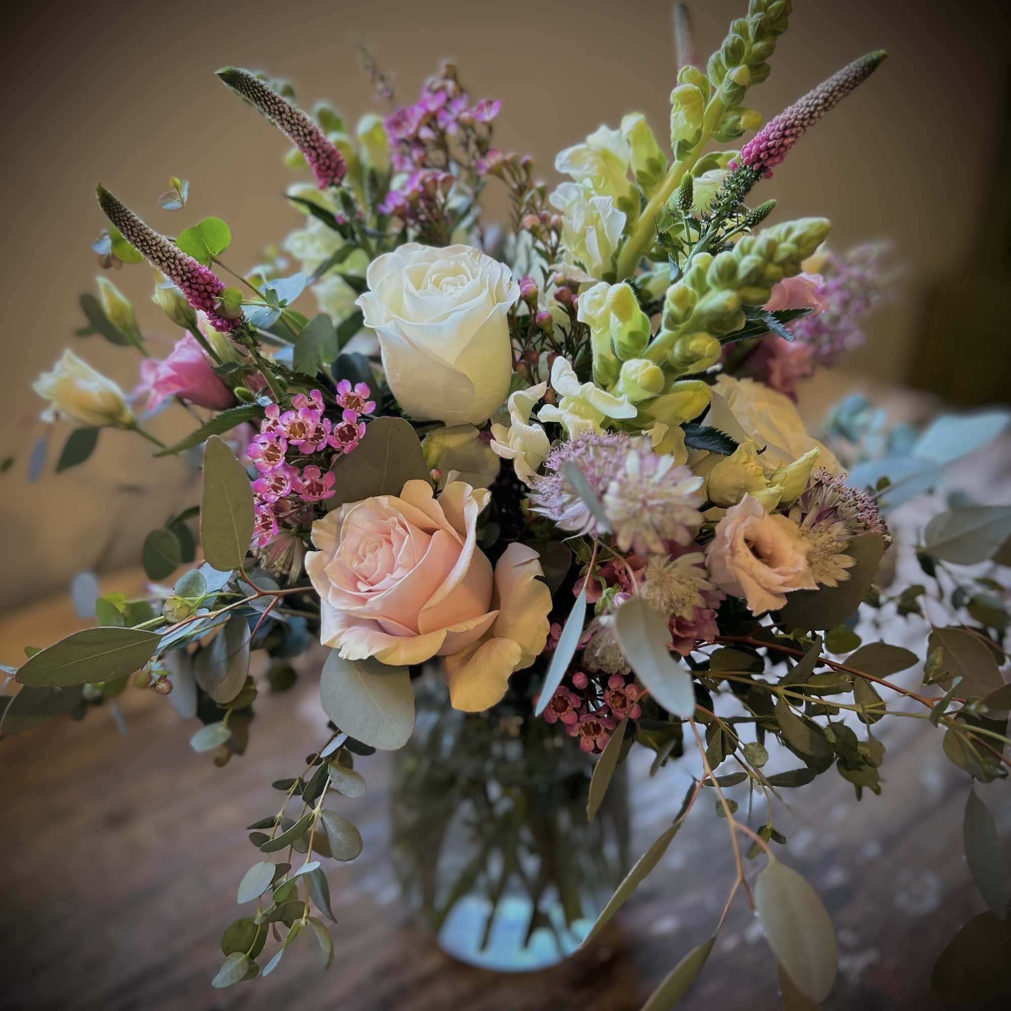 Spring colors and soft greens in a loose garden style, gathered in