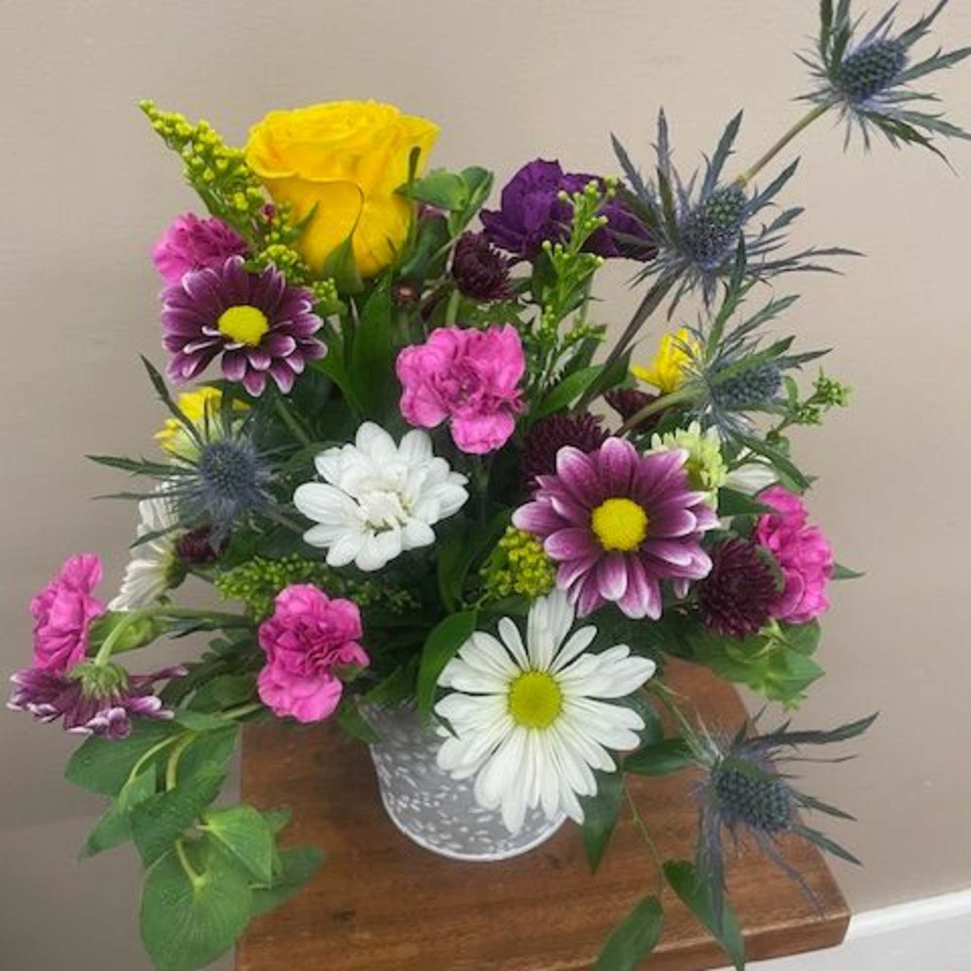 Our mixed flower containers are overflowing with a variety of flowers and