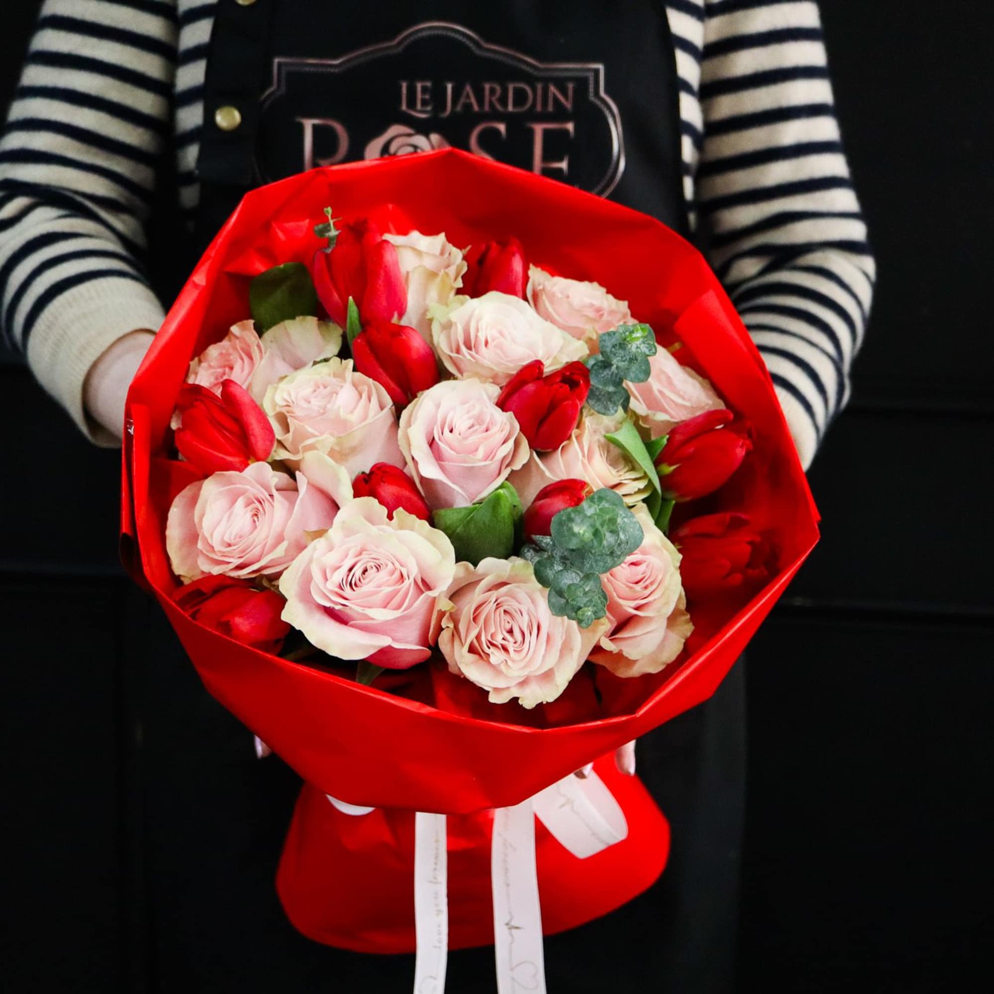 A simple and elegant of 12 pink roses and 10 red tulips.