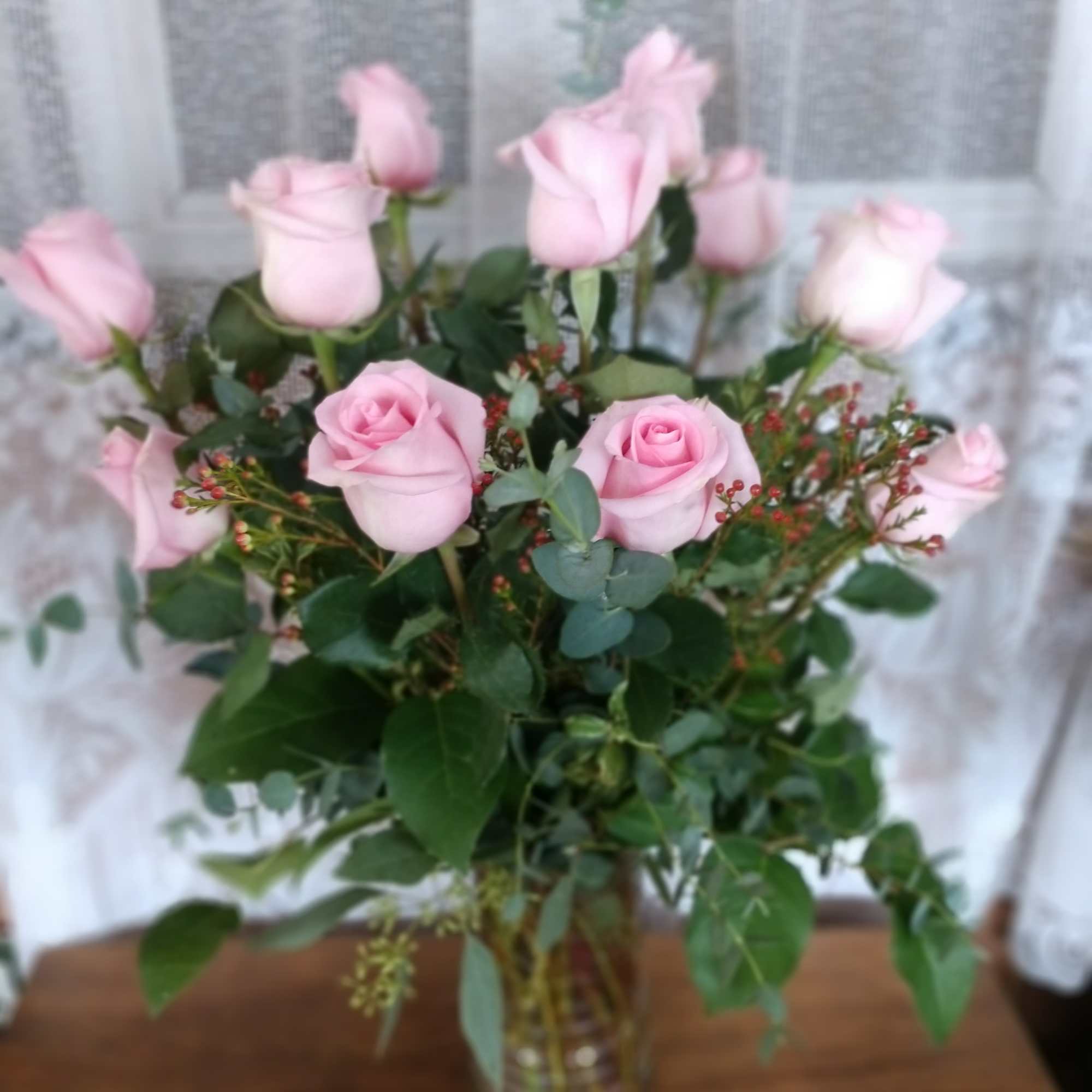 Say it sweeter with this feminine bouquet of pink roses and lush