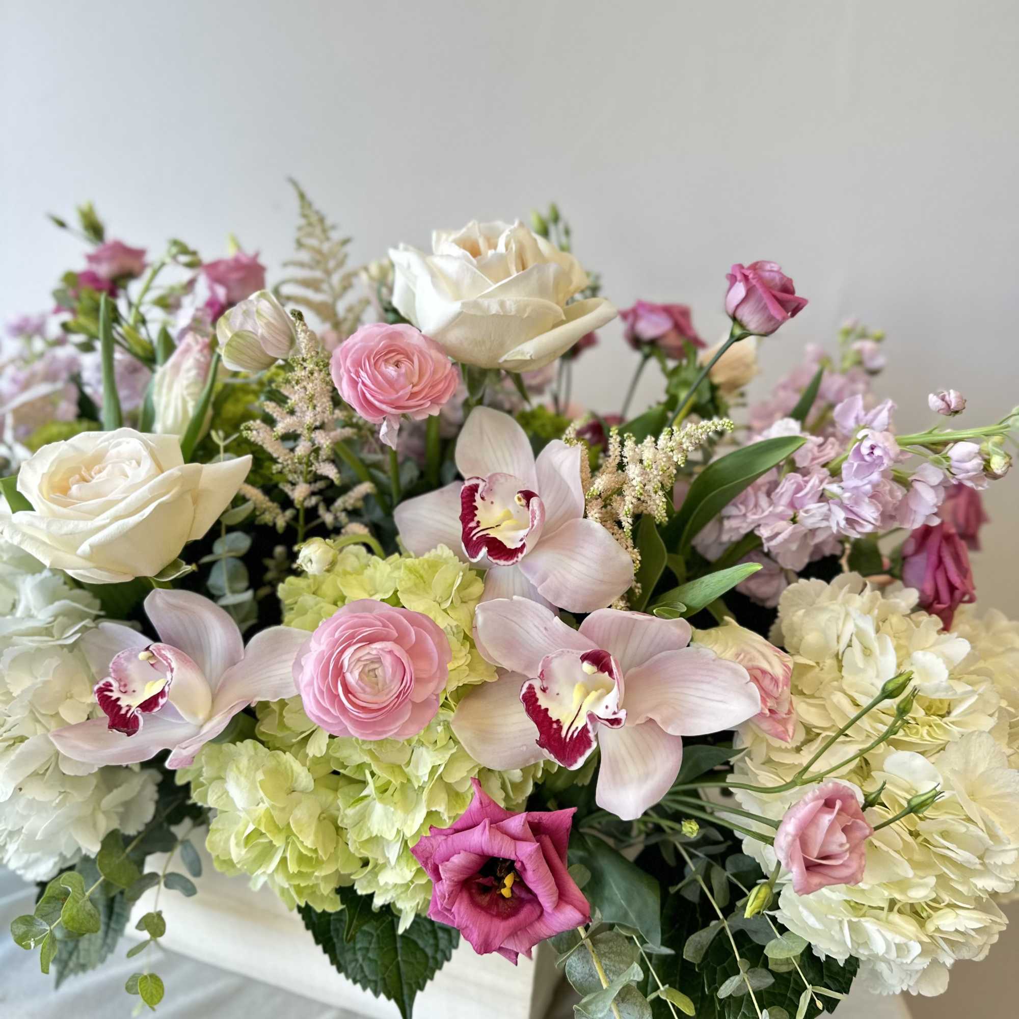 An extravagant arrangement of dazzling flowers in a large oblong planter box.