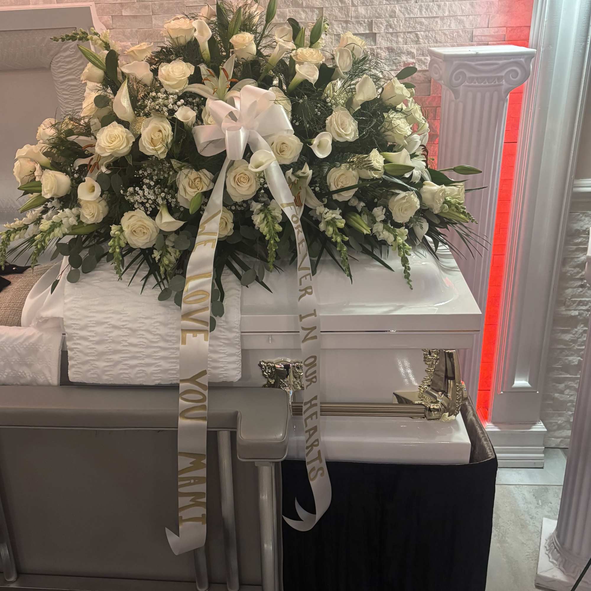 Casket spray mixed roses, lilies, and more 