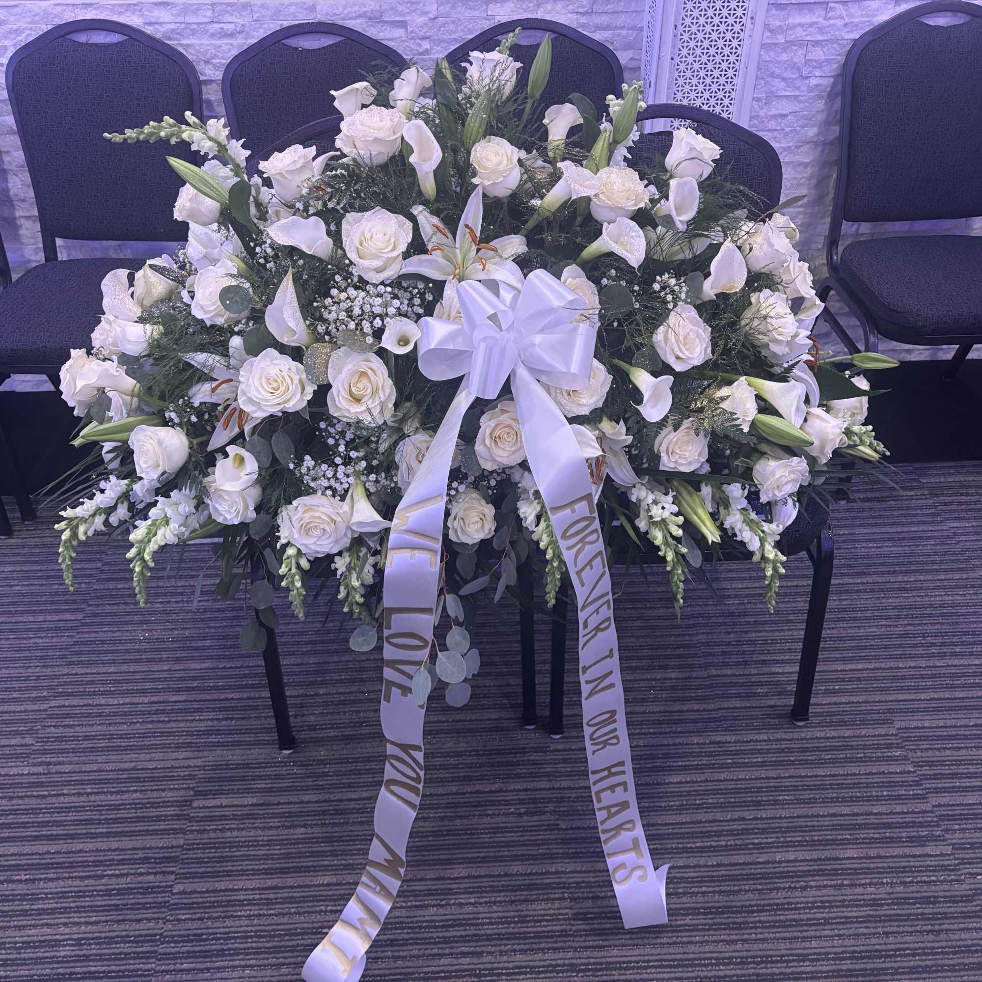 Casket spray mixed roses, lilies, and more 