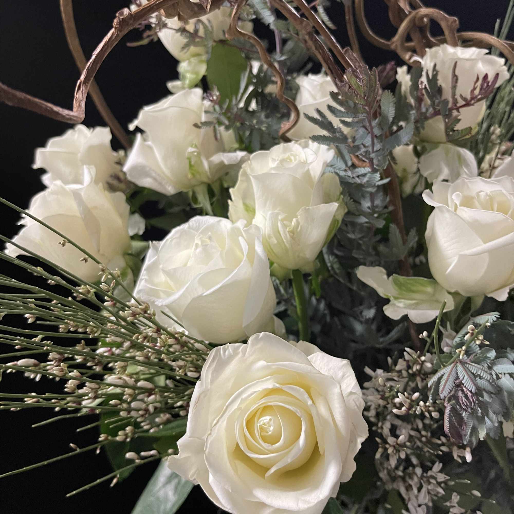 Tall two dozen in stunning vase and surrounded by beautiful greens and