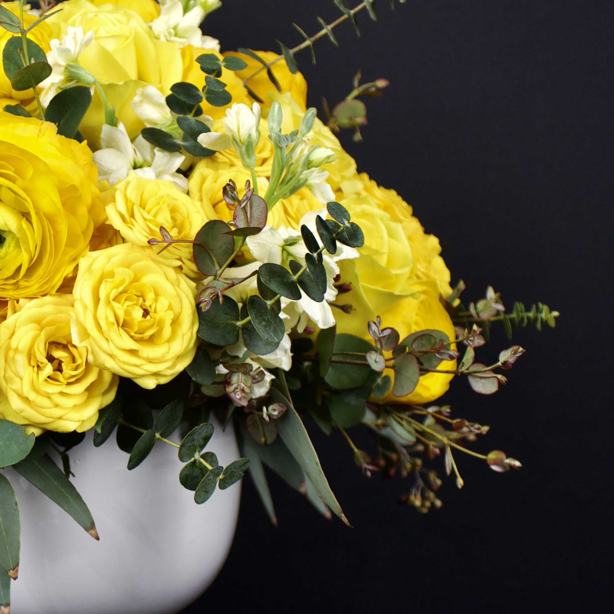 Traditional and contemporary rose flower arrangement designed in a ceramic round white