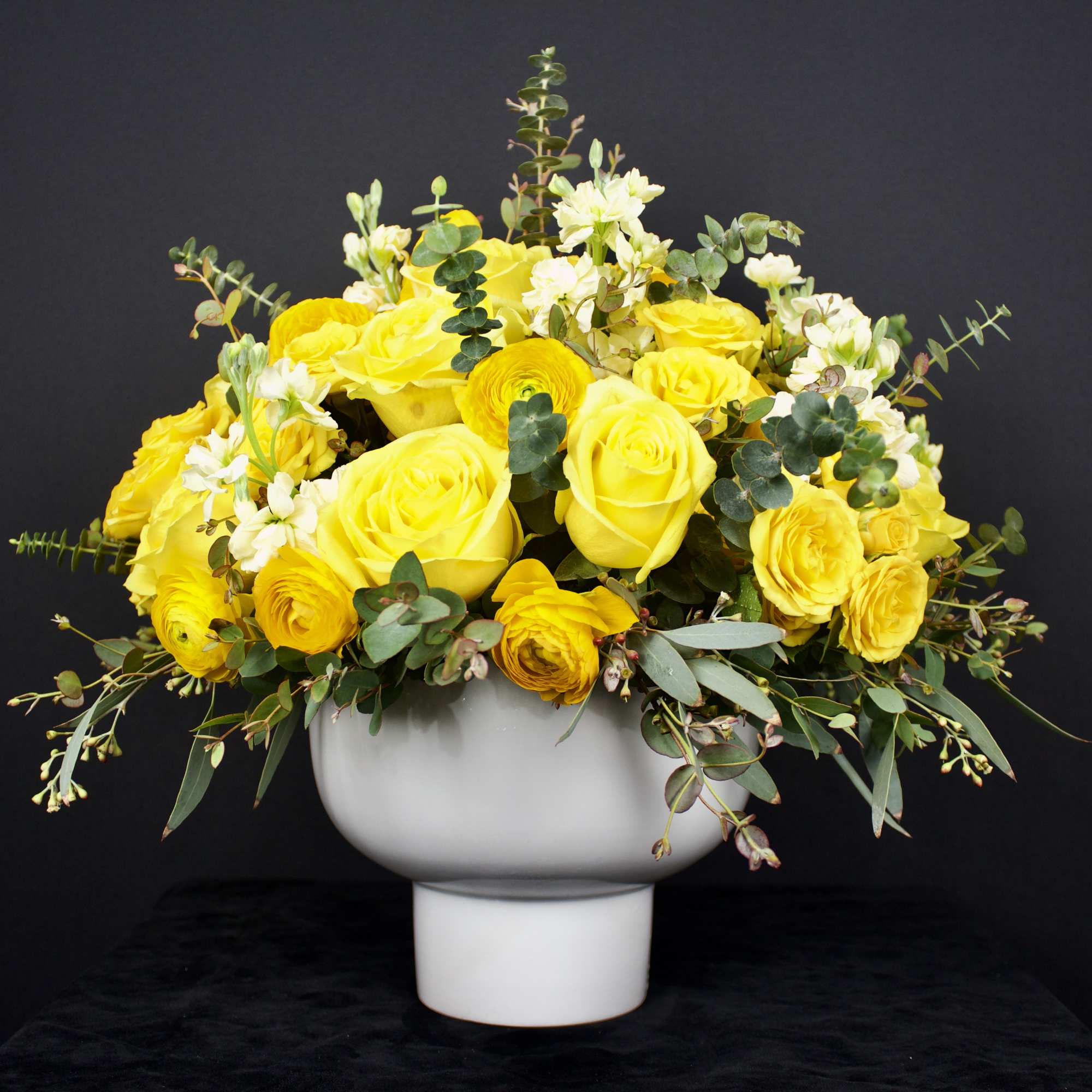 Traditional and contemporary rose flower arrangement designed in a ceramic round white