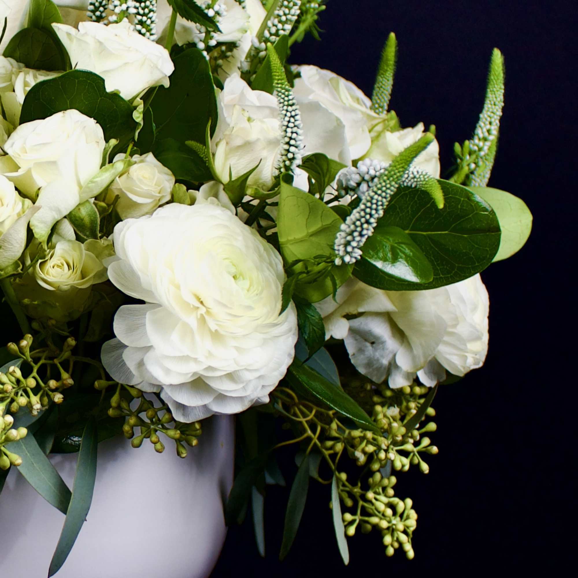 Traditional and contemporary rose flower arrangement designed in a ceramic round white