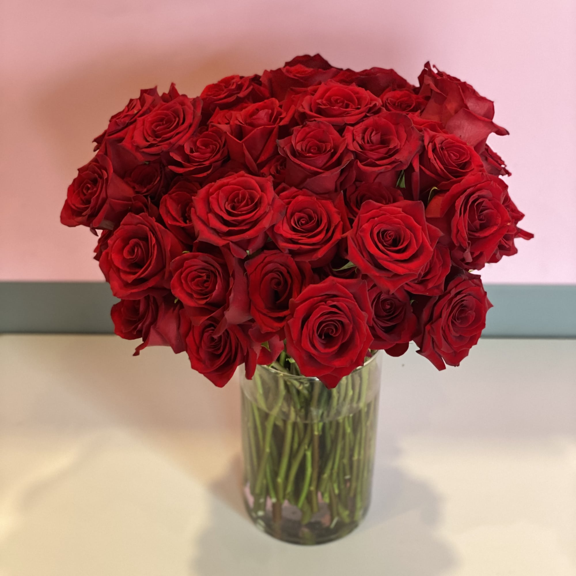 This stunning vase arrangement is comprised of 100 lush red roses. This