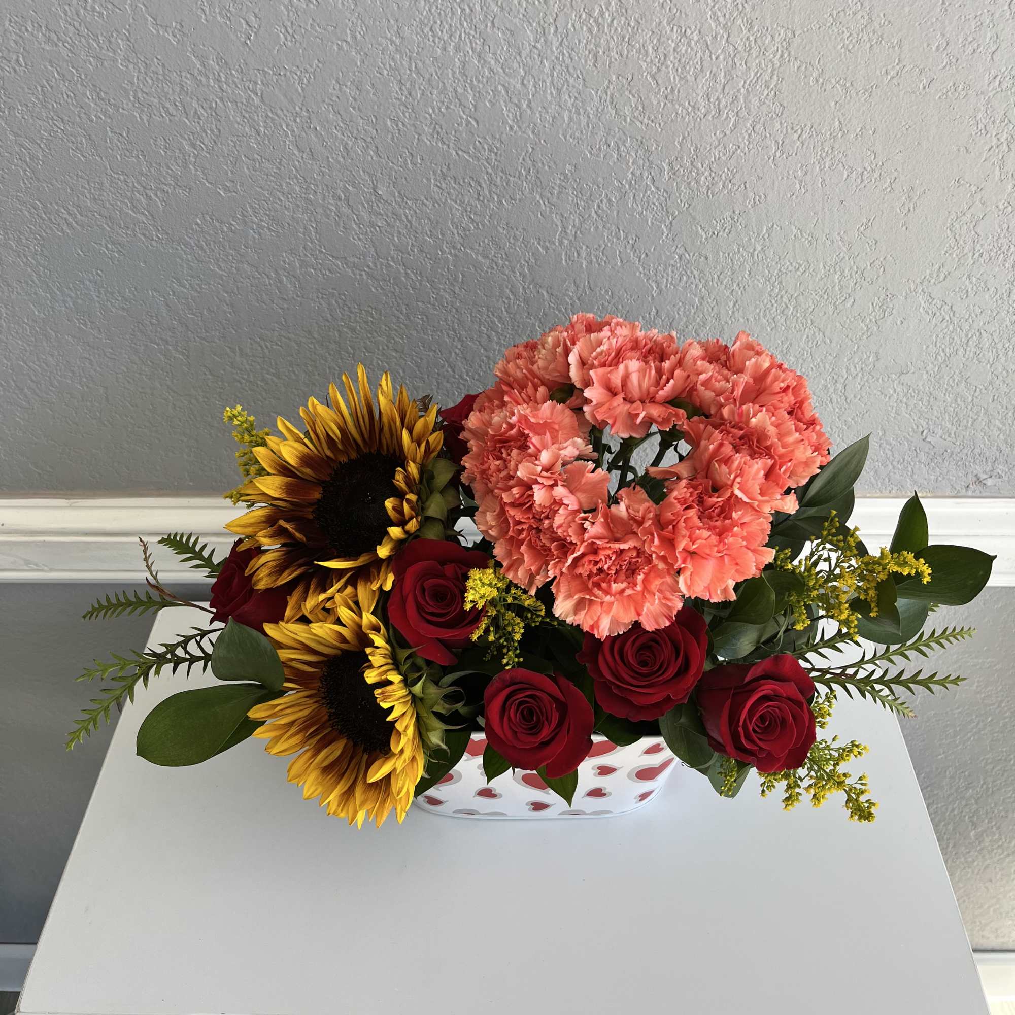 Heart made of carnations with sunflowers and Roses 