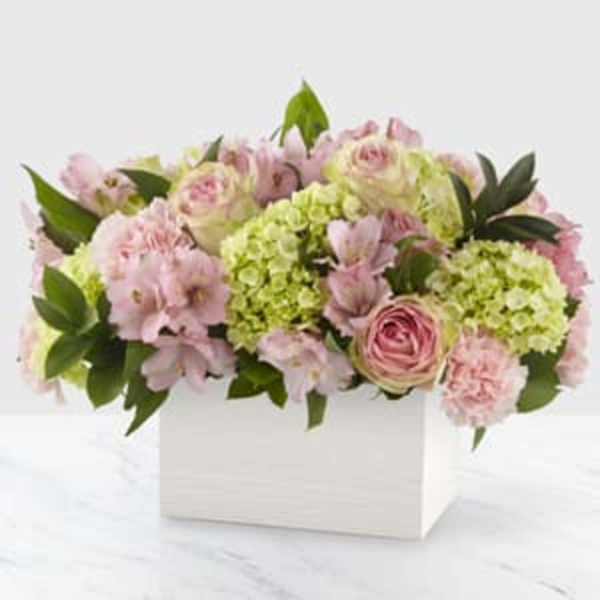 The true beauty in this arrangement is in the soft hues, sweet