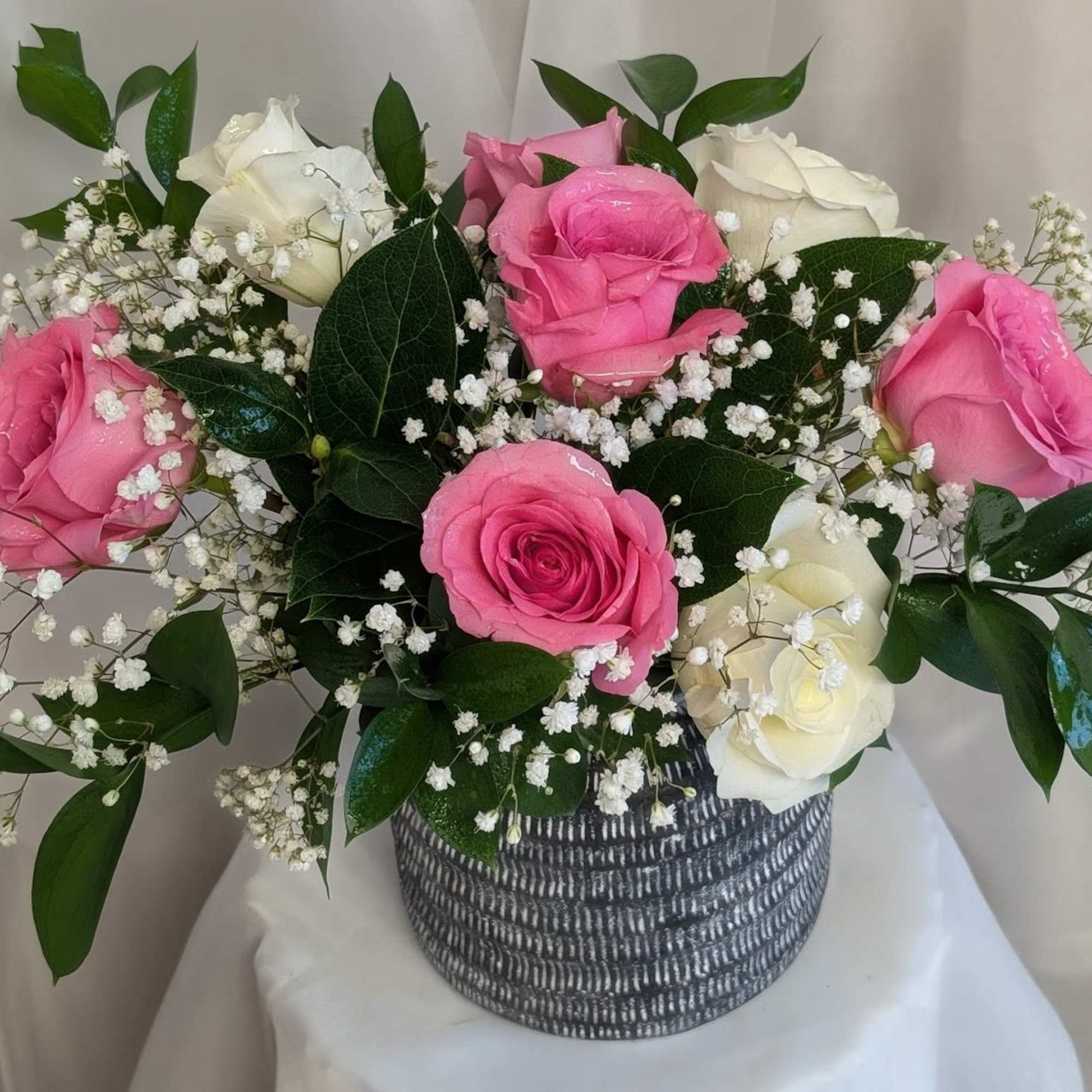 Beautiful pink and white roses with a touch of babies breath and