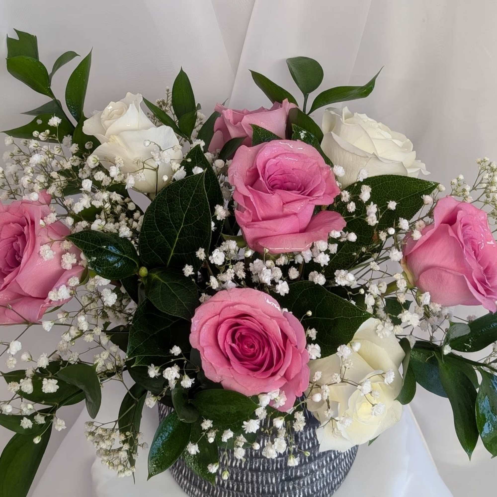 Beautiful pink and white roses with a touch of babies breath and