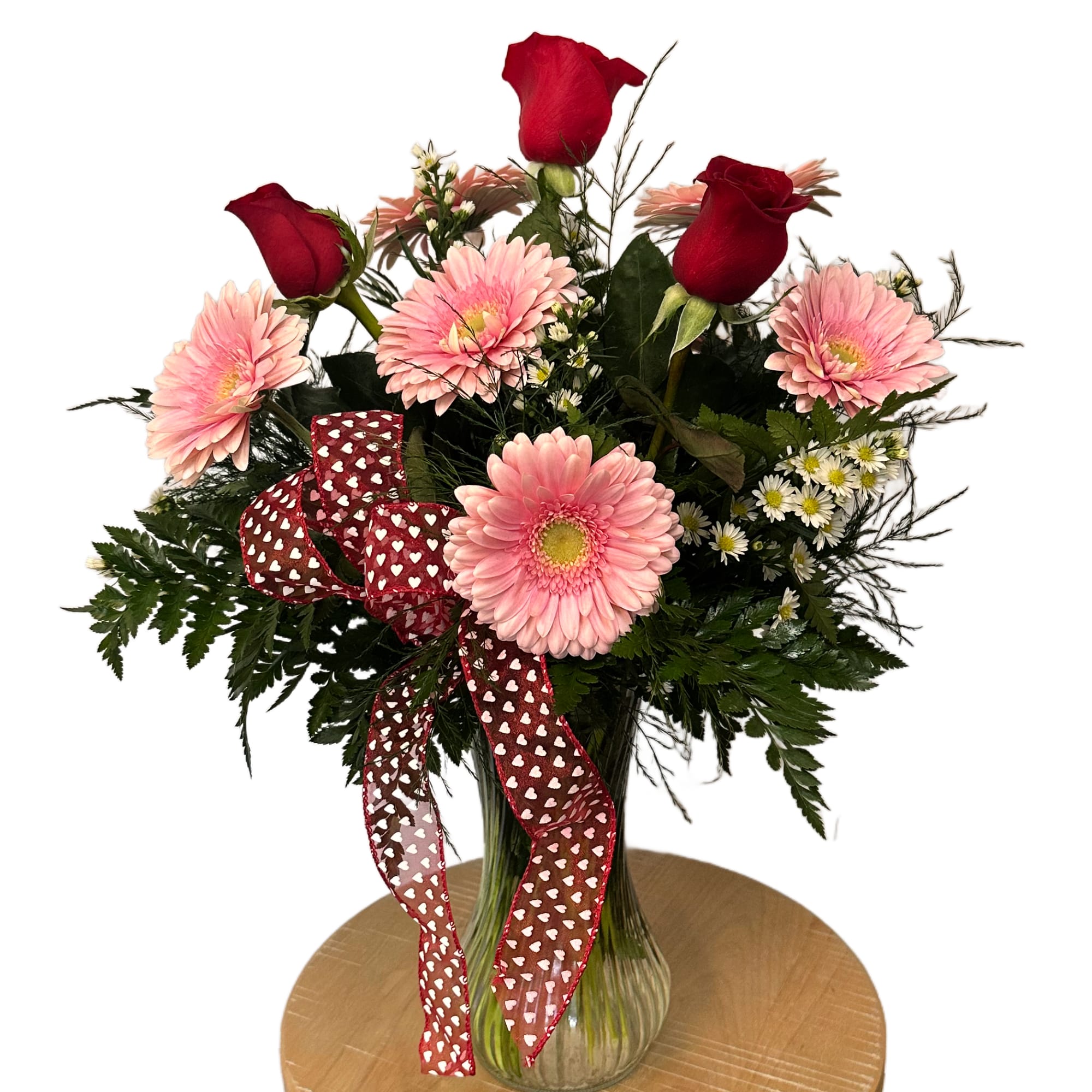 A vibrant mix of Gerber's, roses and accent flowers.
Arrangement comes in frosted