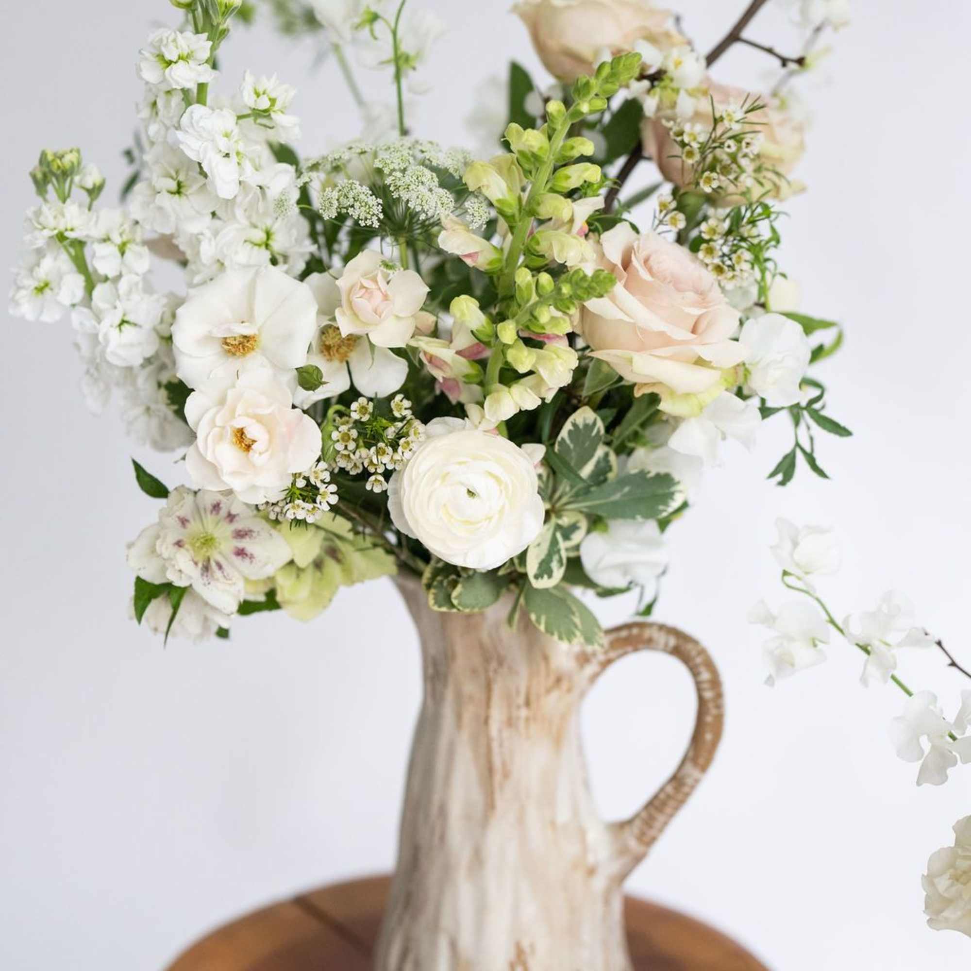 Soft and serene, shades of spring green, cloud white and subtle blush