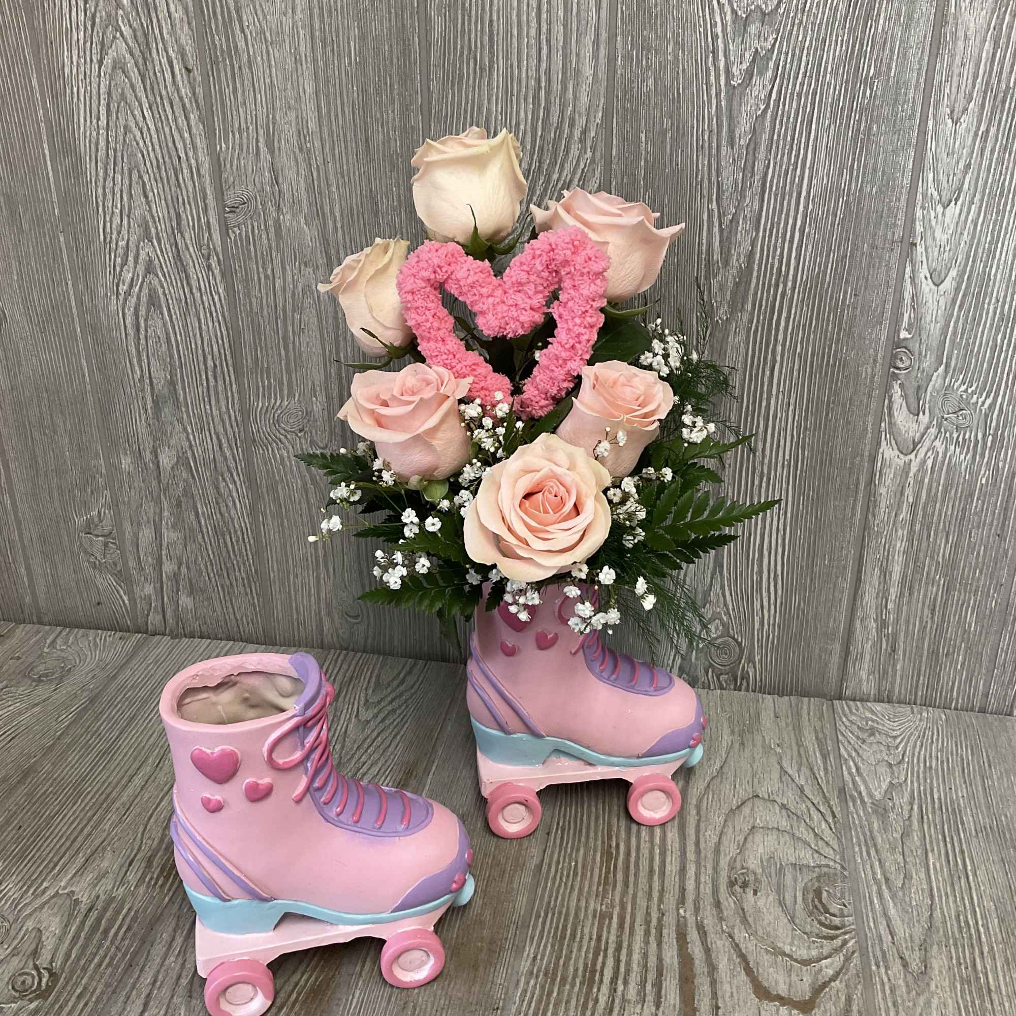 Beautiful light pink roses arranged in a retro keepsake ceramic roller skate