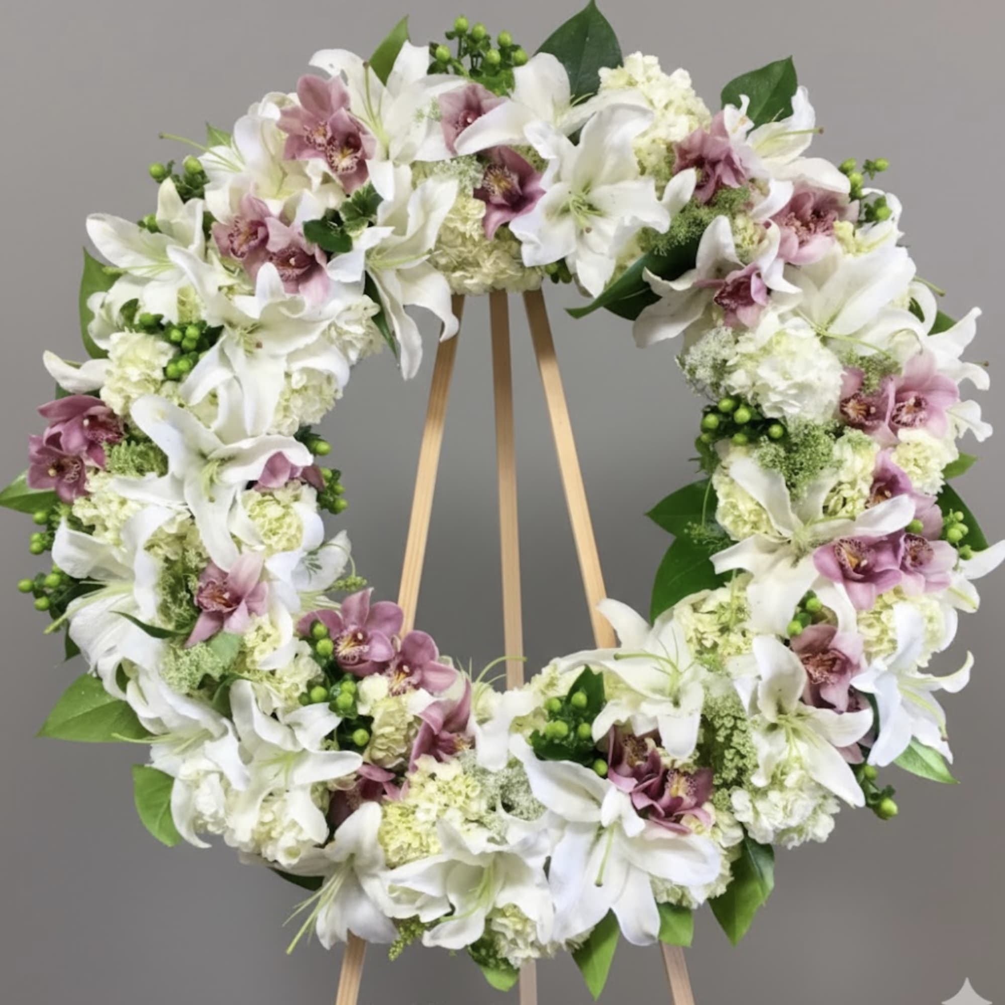 Orchids, lilies, and hydrangeas wreath. Standard size measures approximately 30 inches wide.