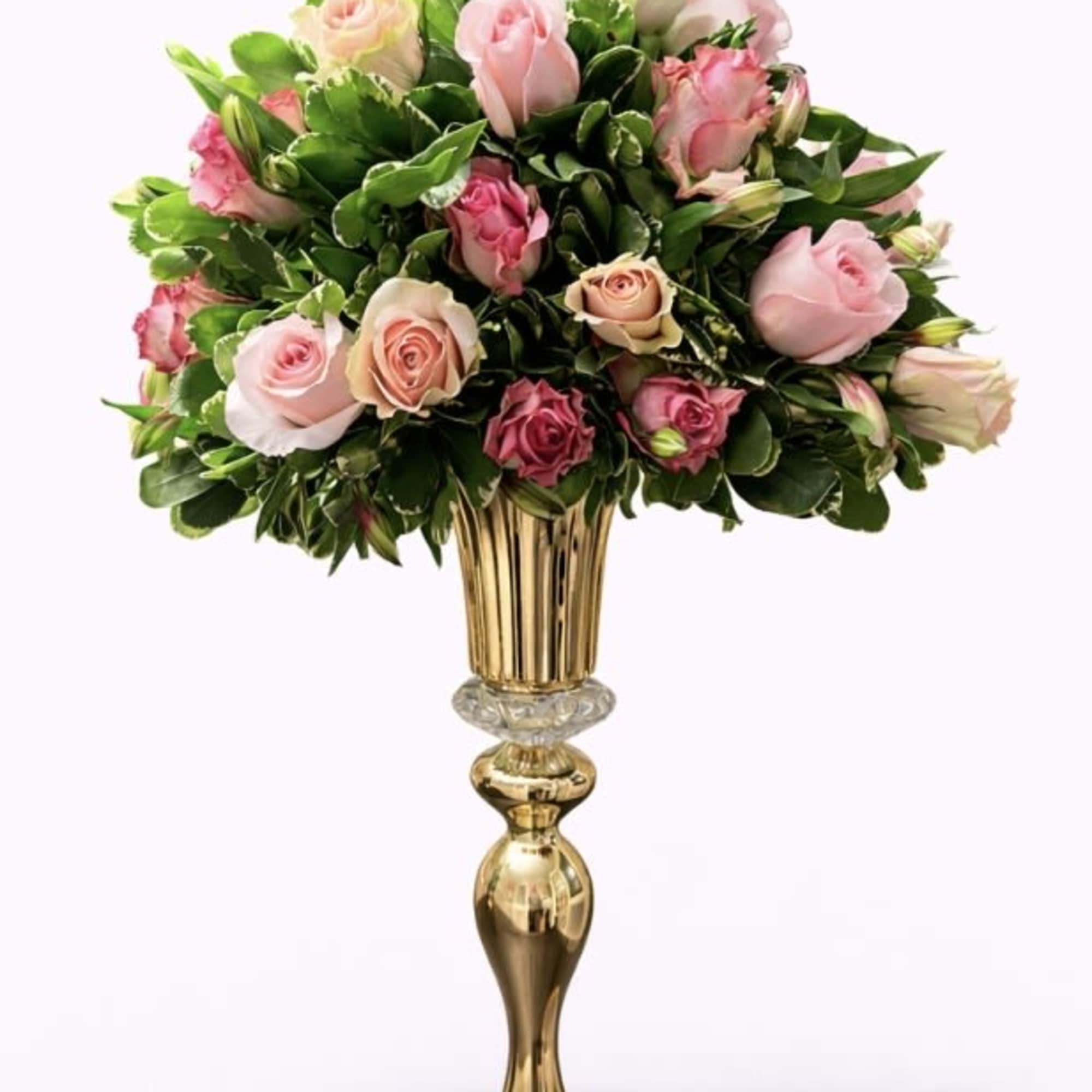 An elegant and sophisticated floral arrangement designed in a classic gold pedestal