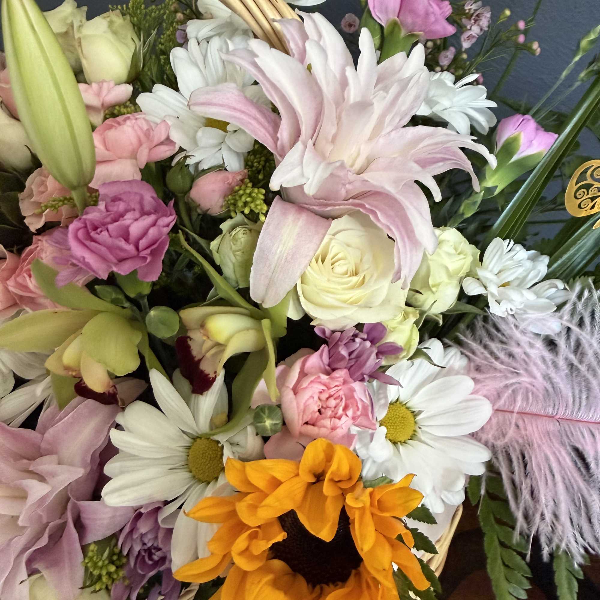 An enchanting garden-style luxury basket overflowing with delicate blush and pastel blooms