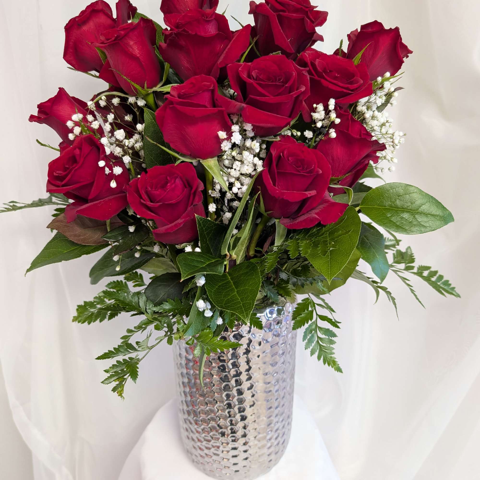 Premium two dozen Red Roses along with baby's breath and greenery in